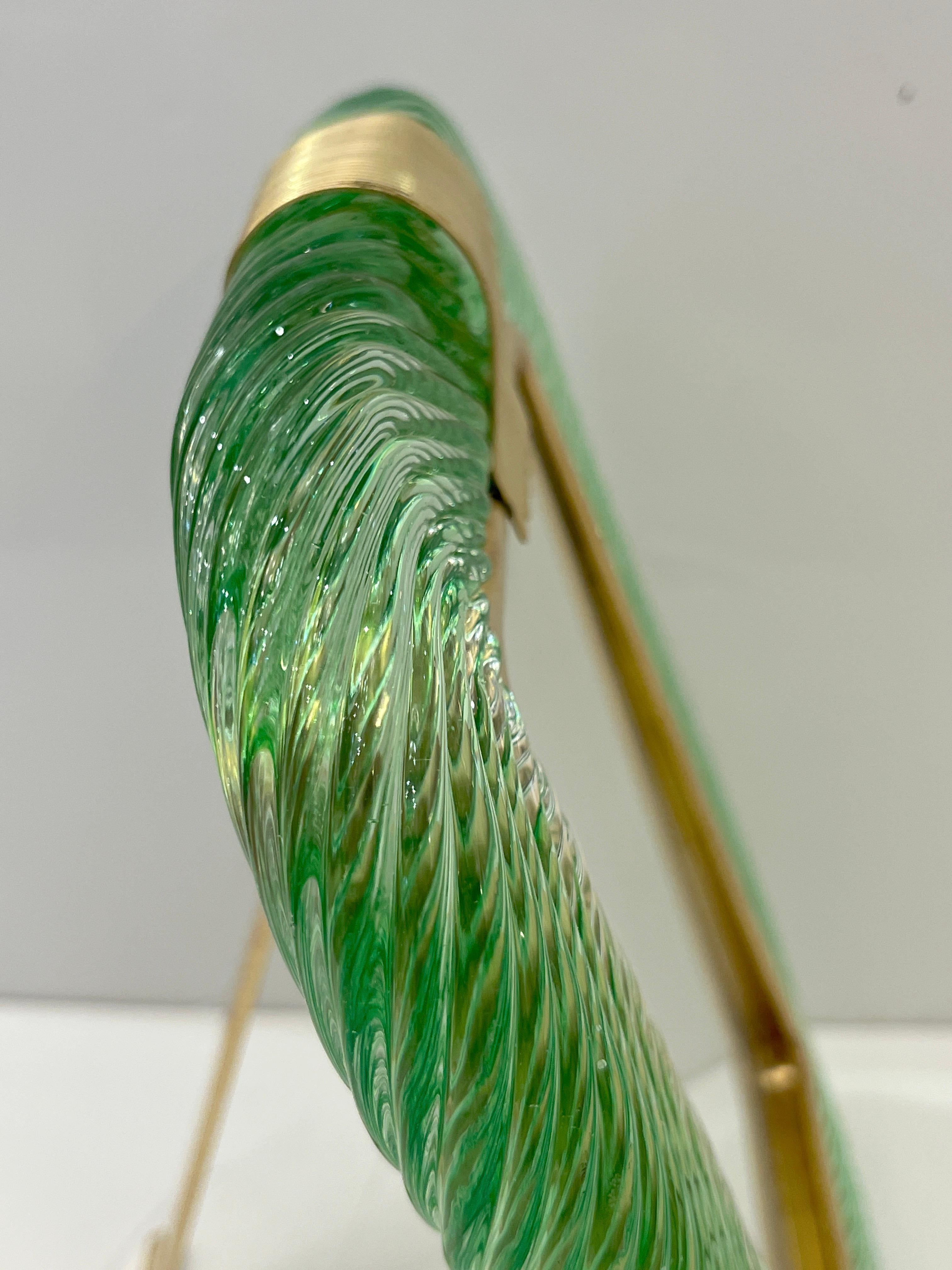 A sophisticated Venetian modern design vertical photo frame in thick blown Murano glass worked in a pastel lime green color, by Barovier Toso, signed piece. The elegant texture of the tightly twisted glass frame in Torchon of high quality