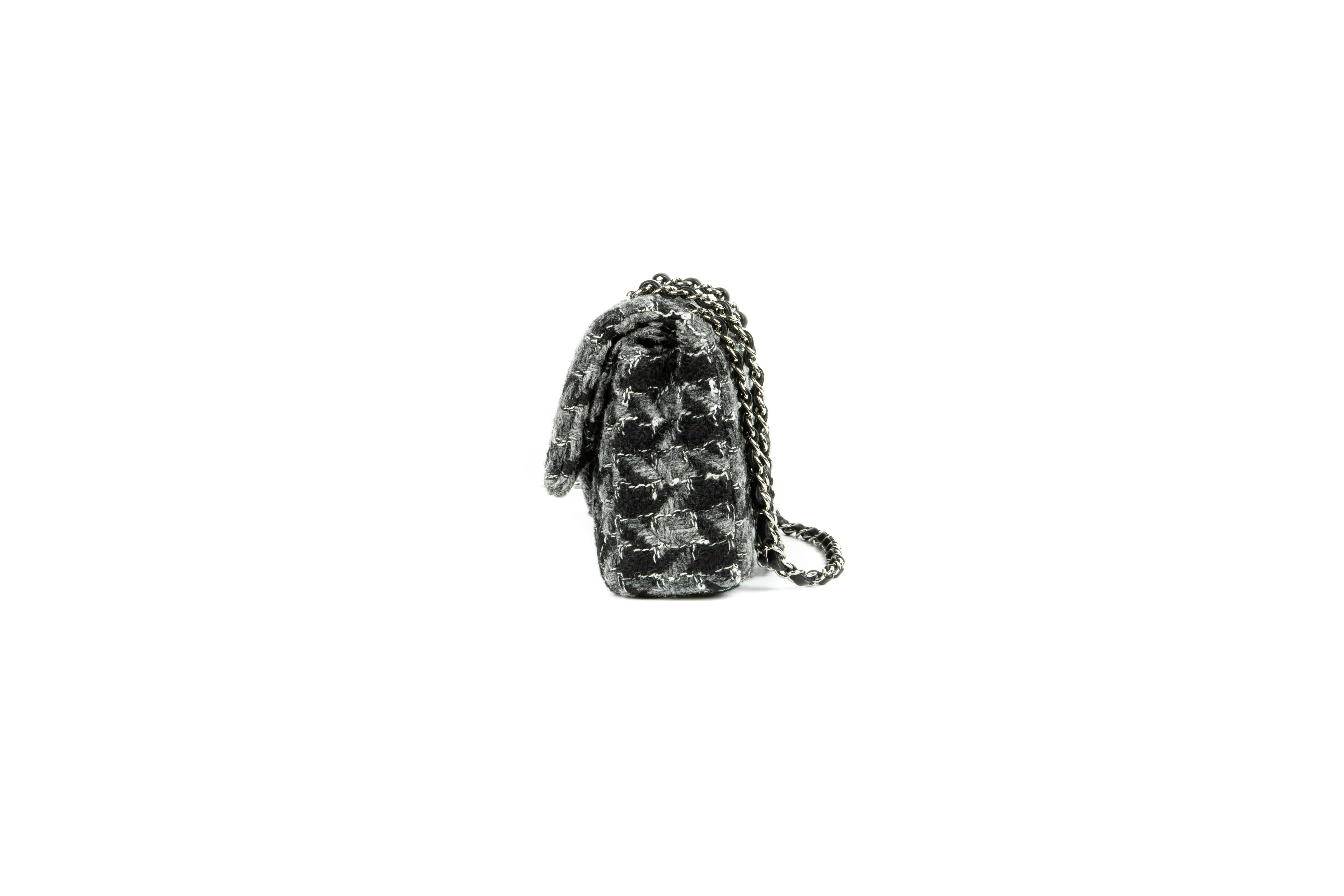 An iconic, rare and highly collectable 2016 Chanel black and slate-grey wool tweed quilted double flap bag, in a large houndstooth design, comprising of one compartment with a stitched-down House logo, two gusseted patch pockets, one lipstick