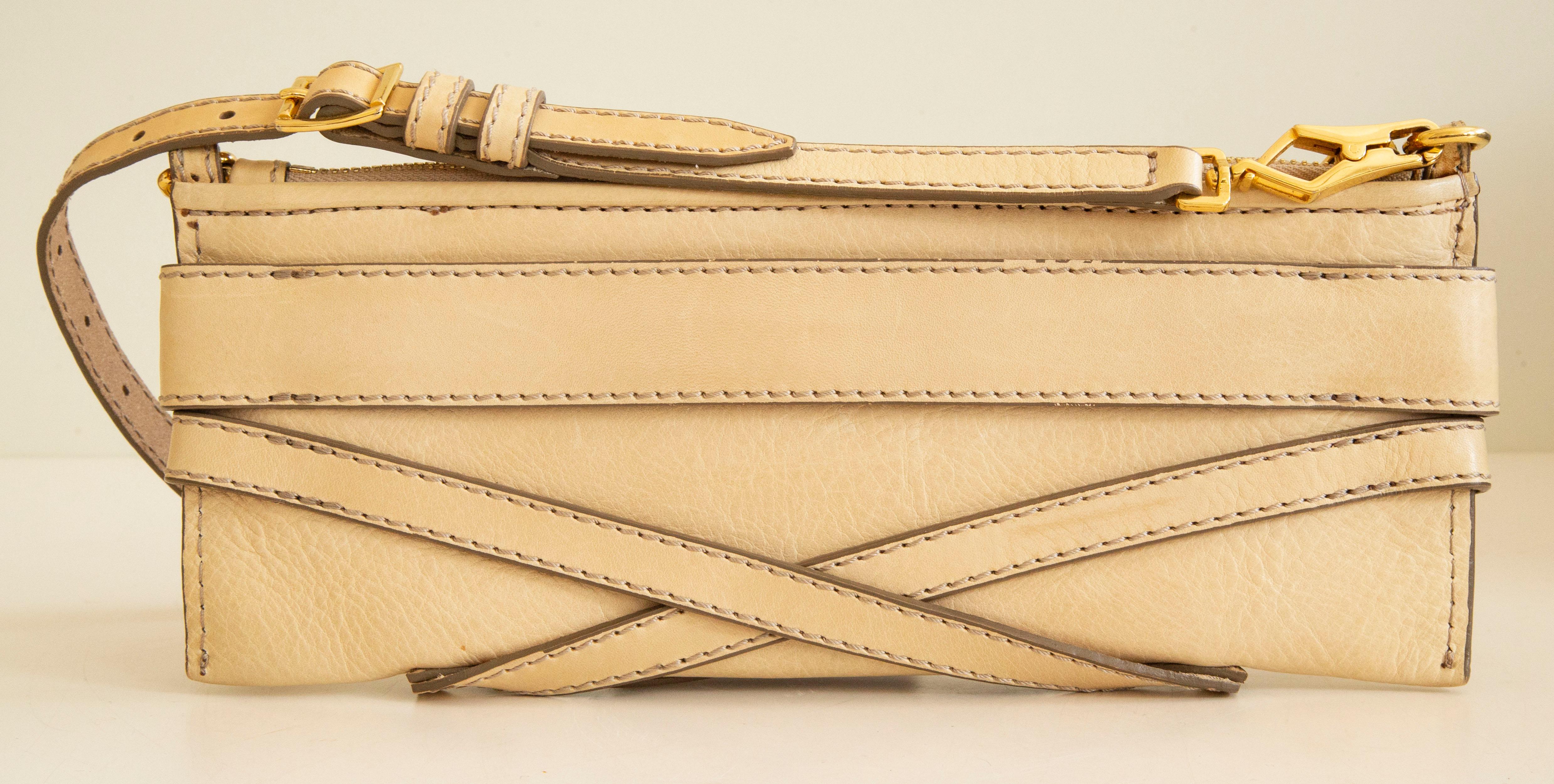 An authentic Burberry clutch. The clutch features a Bridle house design with a beige leather exterior and gold-toned hardware. The interior is lined with Burberry House check fabric and it is neat & clean. The bag displays minor to its age general