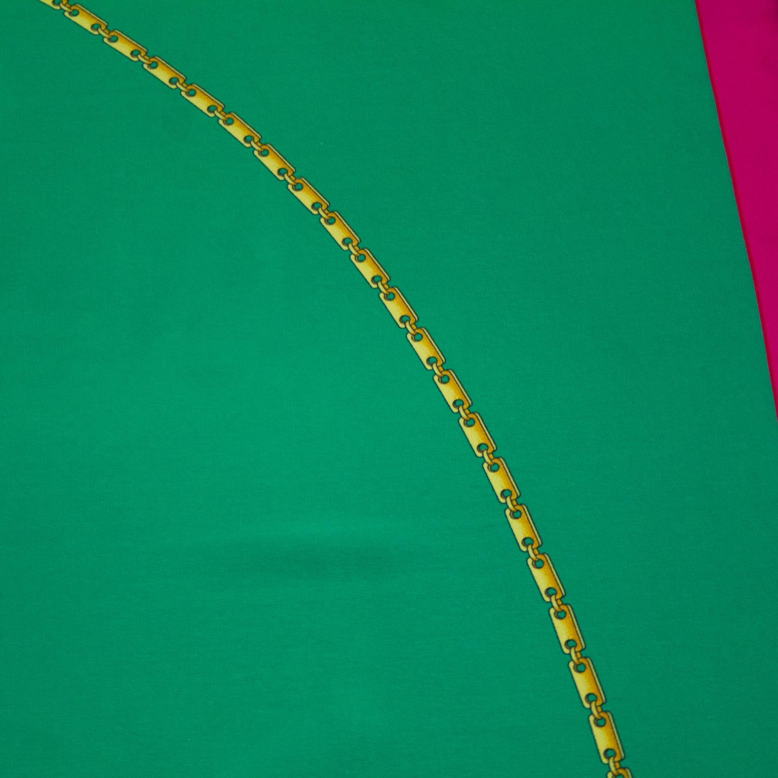 Square Cartier silk scarf from the early 2000's. Green with magenta pink boarder and Cartier logo. Gold link jewllery detail. Cartier markings. Hand sewn rolled hem. Excellent vintage condition. 32