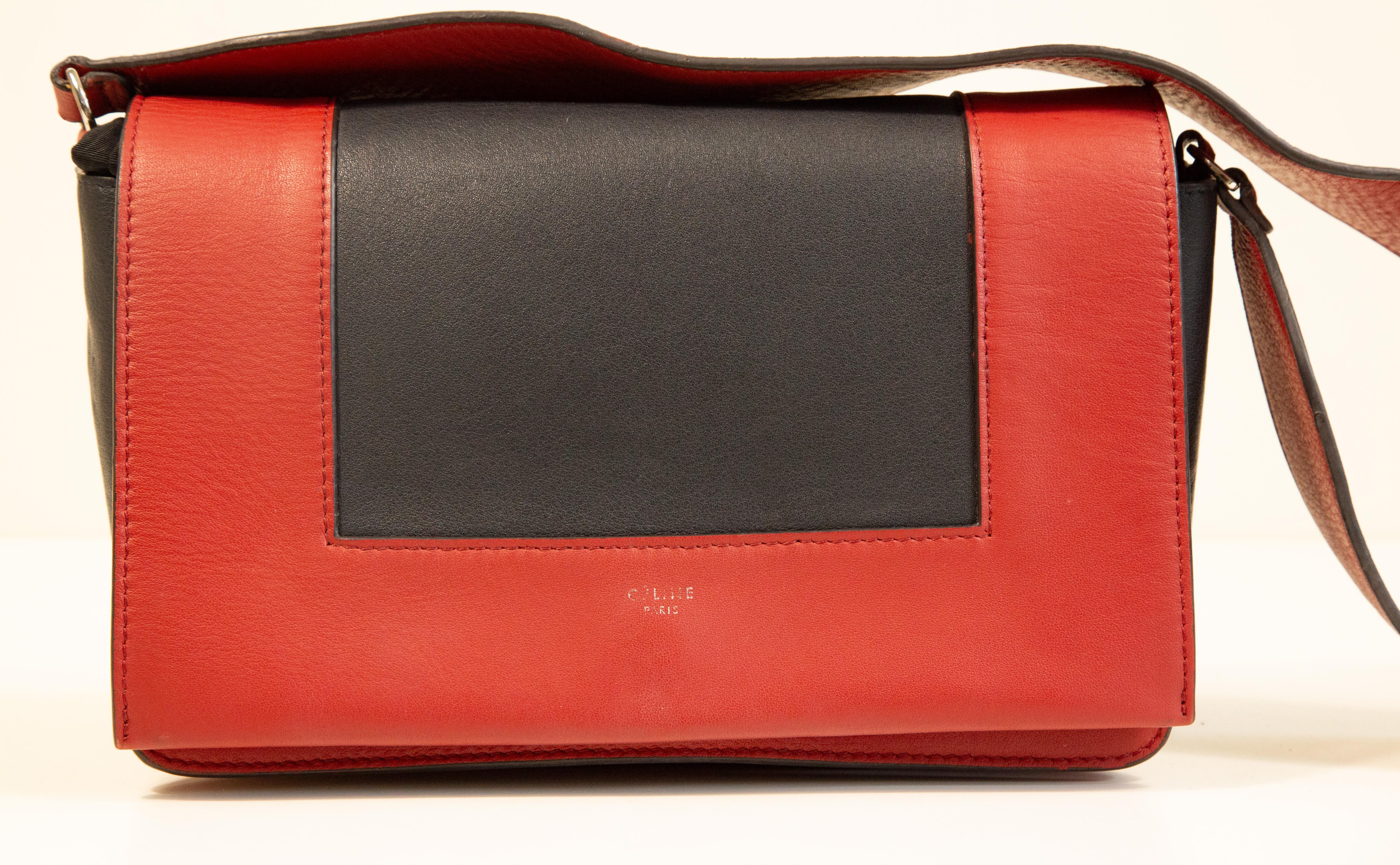 Celine Frame shoulder bag made of red and black anthracite leather with silver toned hardware. The interior is lined with red calf leather and next to the major compartment it features three pockets of which one has a zipper. The length of the
