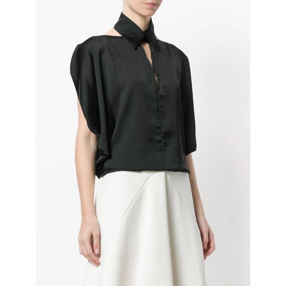 Black Chanel blouse in silk blend with cut-out detail. Model with classic collar and button, wide short sleeves, boat neckline and opening on the back. Soft fit.
Years: 2000s

Made in France

Size: 40 FR

Linear measures

Shoulders: 60 cm
Bust: 60