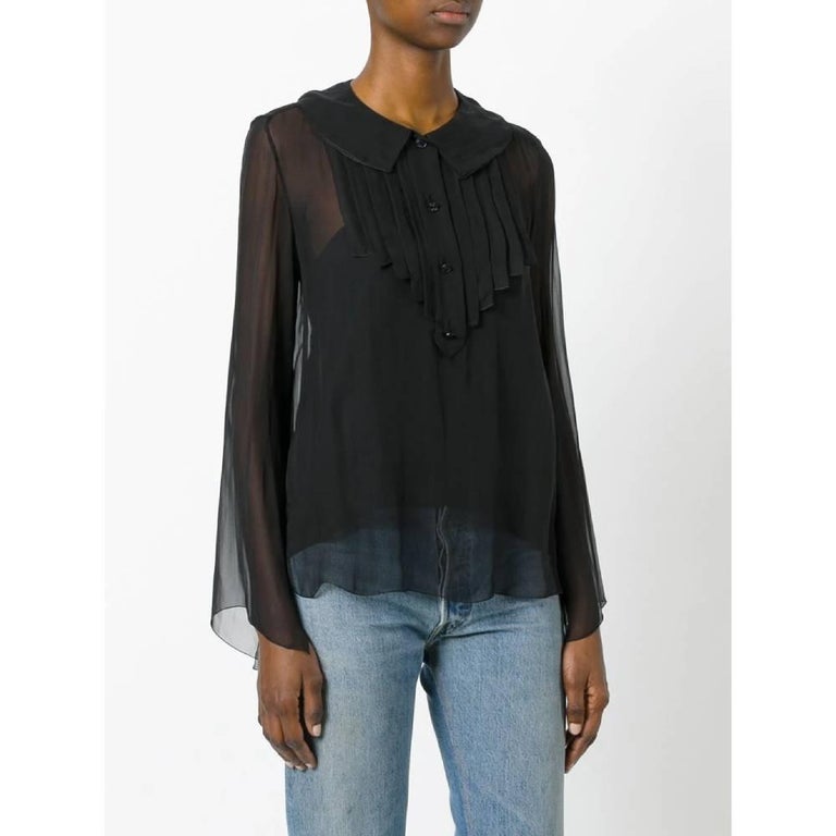 Chanel shirt in transparent black silk with ruffles and front black buttons, long sleeves with wide slit and classic collar.
Years: 2007

Made in France

Size: 38 FR

Linear measures:

Height: 64 cm
Shoulders: 39 cm
Bust: 50 cm
Sleeves: 67 cm