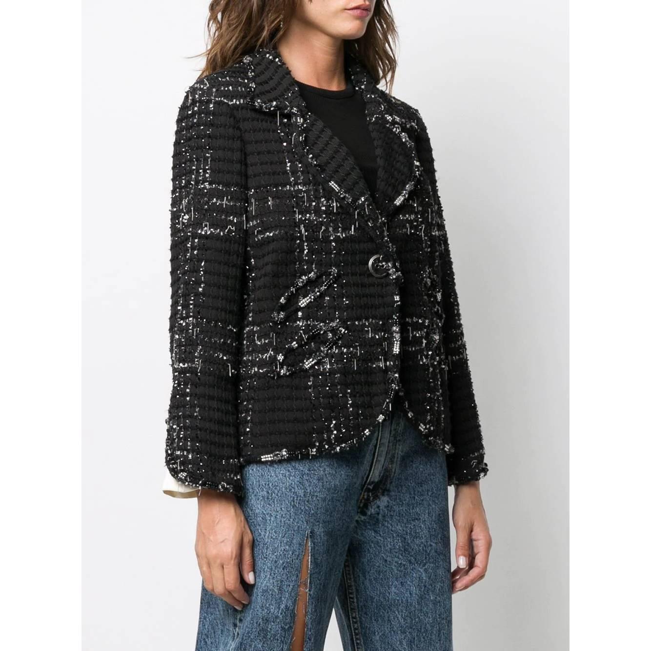 A.N.G.E.L.O. Vintage - ITALY
Chanel black wool blend jacket with silver threads, intertwined chains and decorative beads. Classic lapel collar, front button closure and rounded edges. Long sleeves with slit and double cuff on the bottom.

Years:
