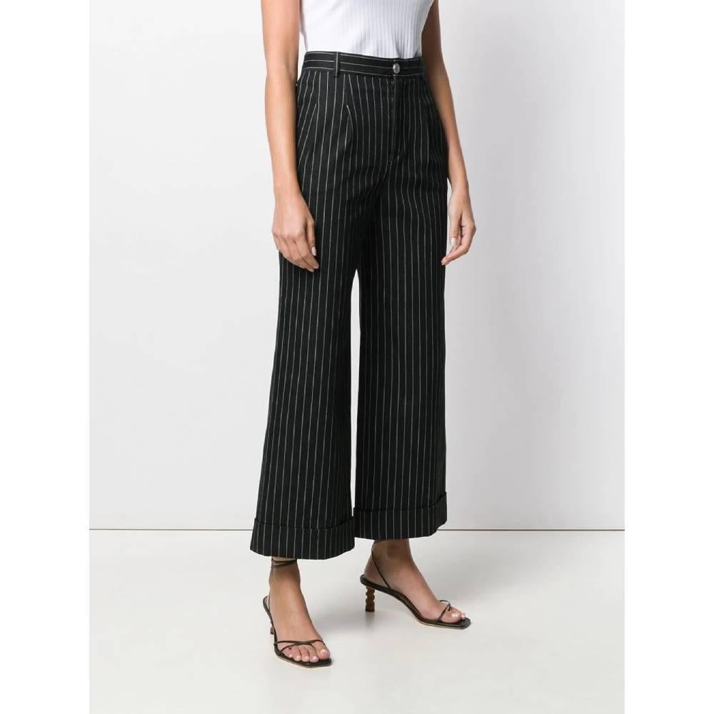 Chanel wide pinstripe in cotton blend trousers. High waist and front closure with zip and button. Side welt pockets inserted in the seam, darts and loops at the waist. 
Years: 2010s

Made in Italy

Size: 36 FR

Linear measures

Height: 95 cm
Waist: