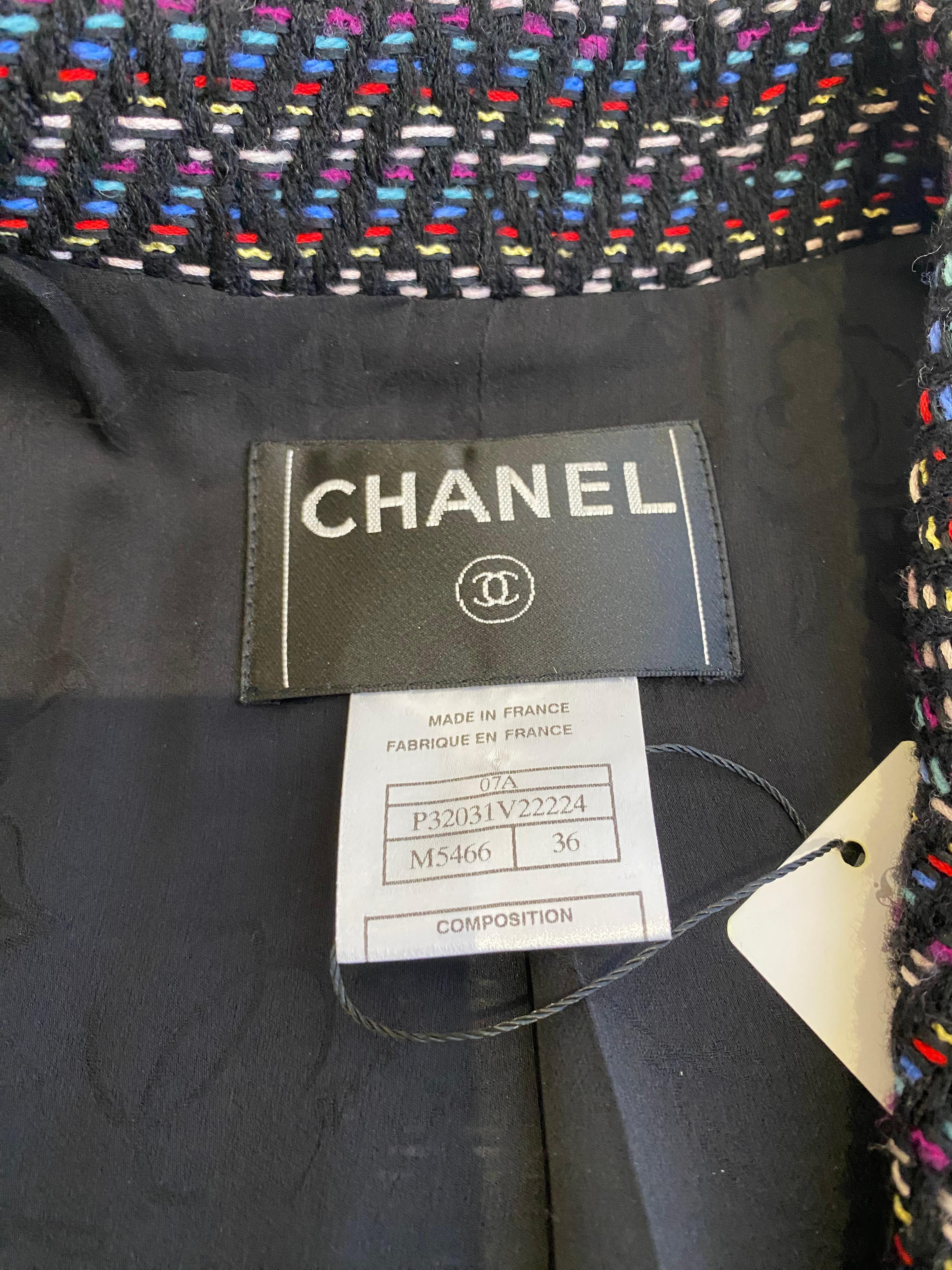 2007 Chanel Black, red, blue , pink, yellow and white wool tweed coat dress with patent leather belt. Lined in silk and chanel camellia logo.  Marked size 36F
fit US 4
- pockets
- buttons
