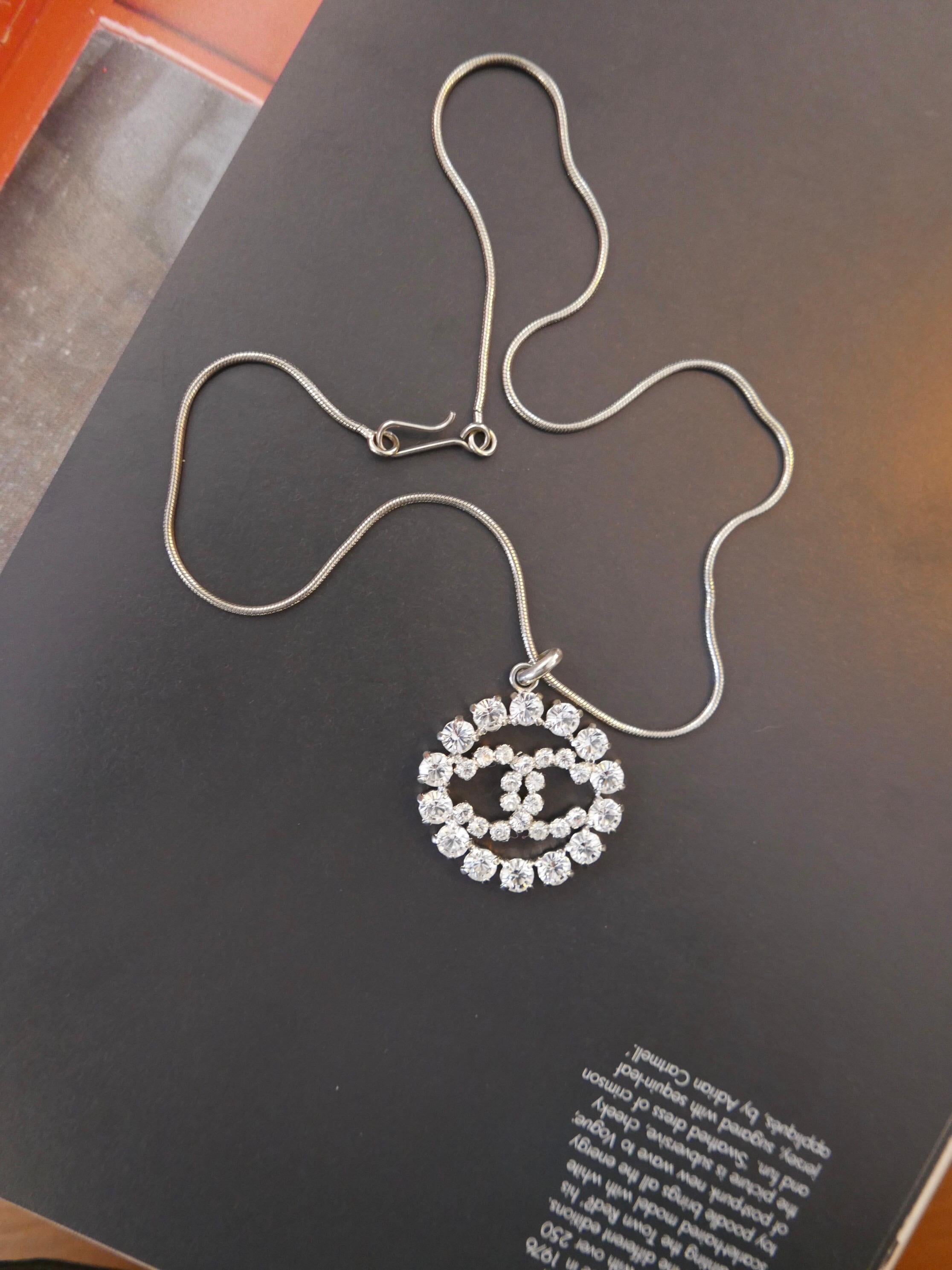 This year 2000 Chanel silver toned necklace features a rhinestone encrusted CC pendant. Measures 43cm Charm 3.2cm. Stamped 00A made in France. Comes with box.

Condition - Minor signs of wear. Generally in good condition.