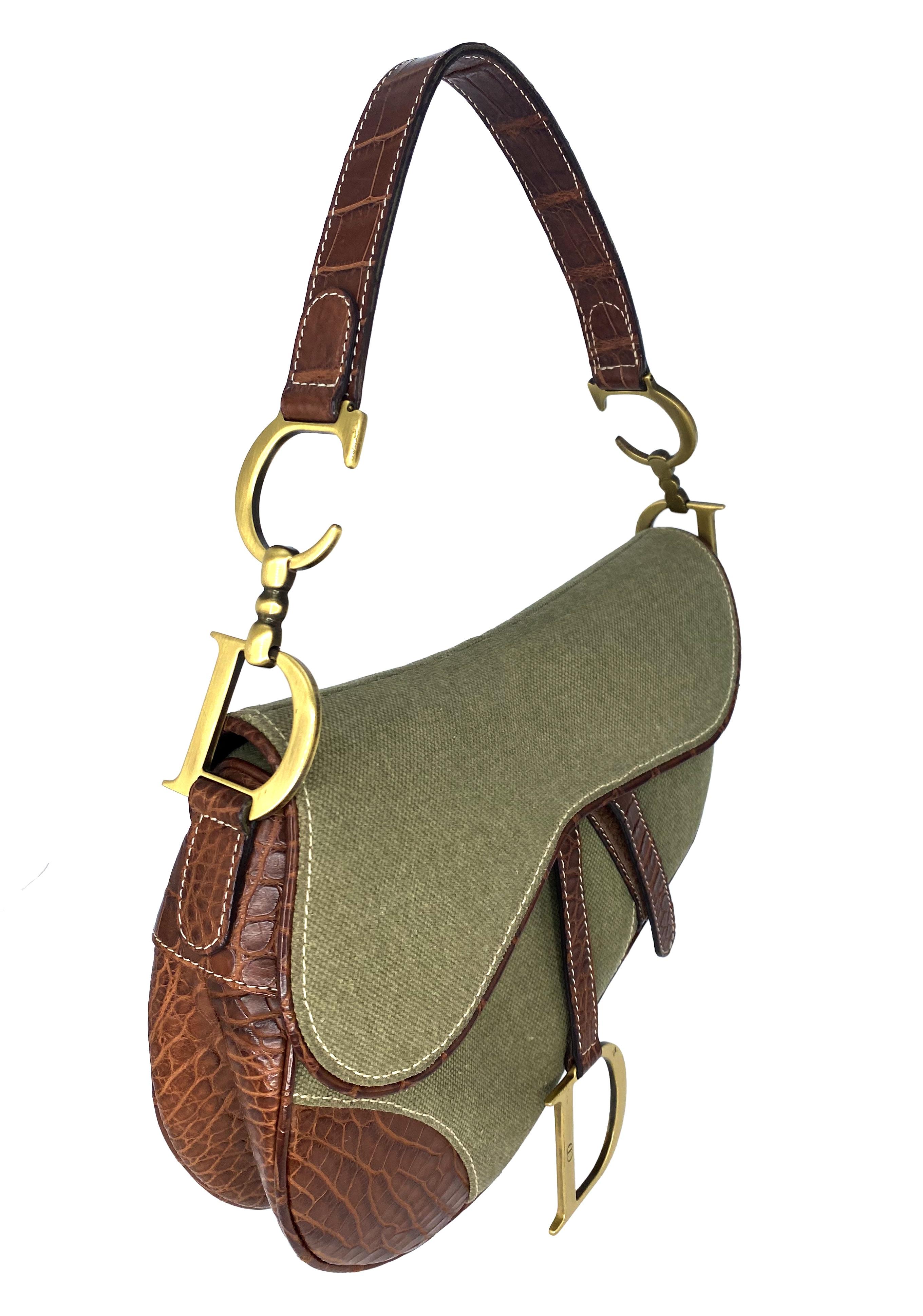 TheRealList presents: a rare variation of the iconic saddle bag designed by John Galliano for Christian Dior constructed of brown crocodile/alligator embossed leather and olive green canvas. The saddle bag first debuted in 1999 for Dior's