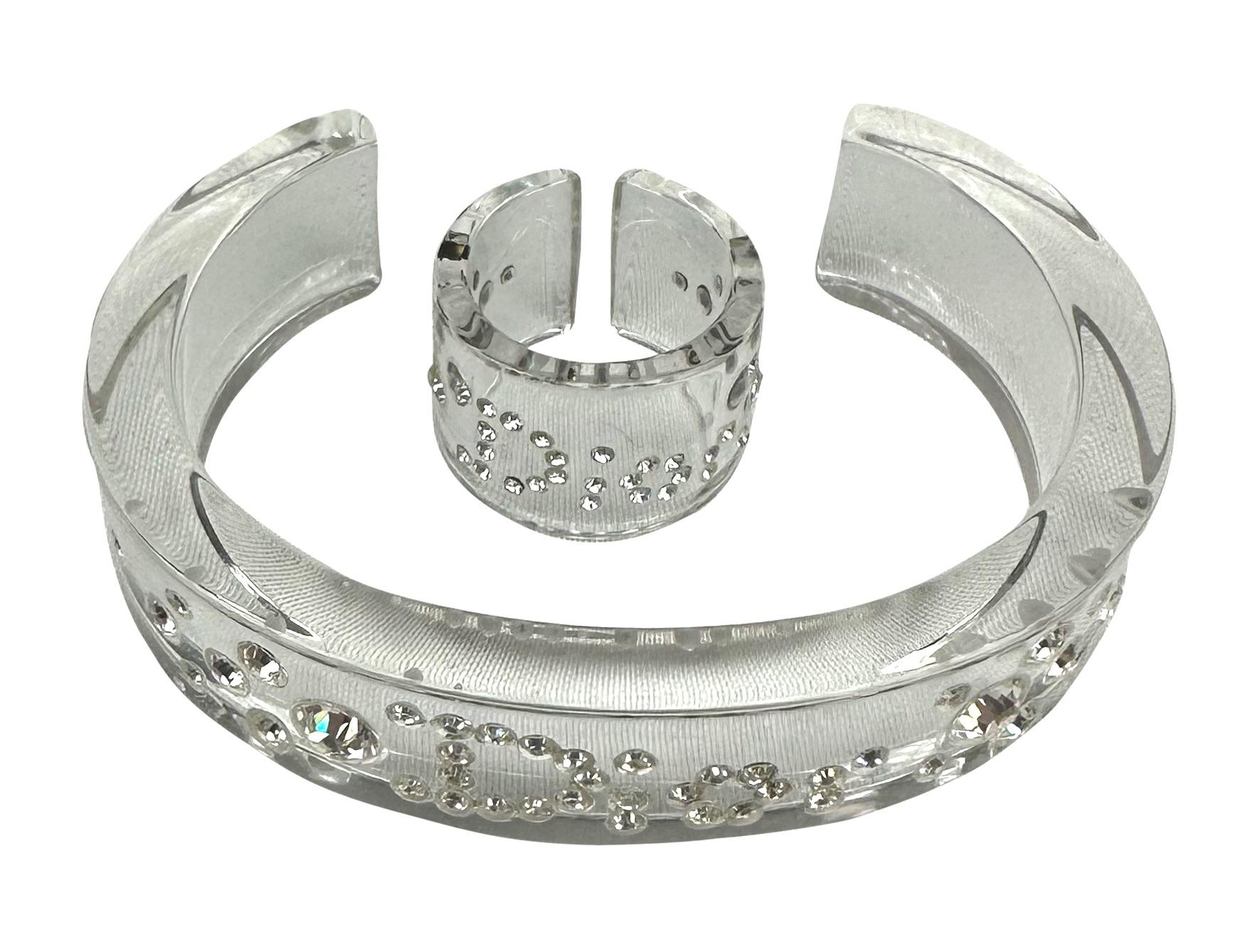 Presenting a clear crystal Christian Dior cuff and ring set, designed by John Galliano. From the early 2000s, this lucite set is the perfect Y2K addition to any outfit. 

Approximate Measurements:
Length: 0.6