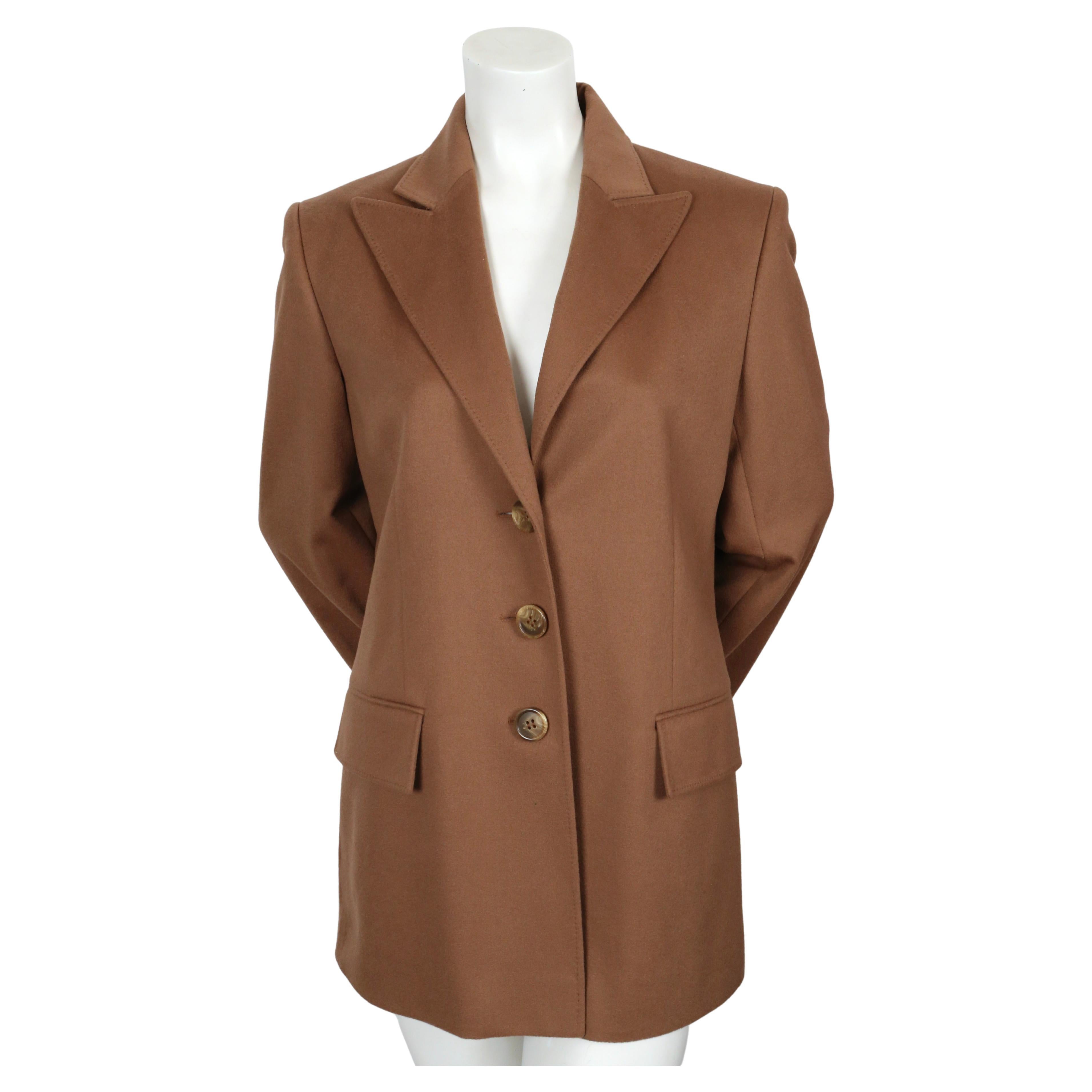 Classic sienna-brown cashmere blazer from Christian Dior dating to the early 2000's. Labeled a French 40. Approximate measurements: shoulder 16.75