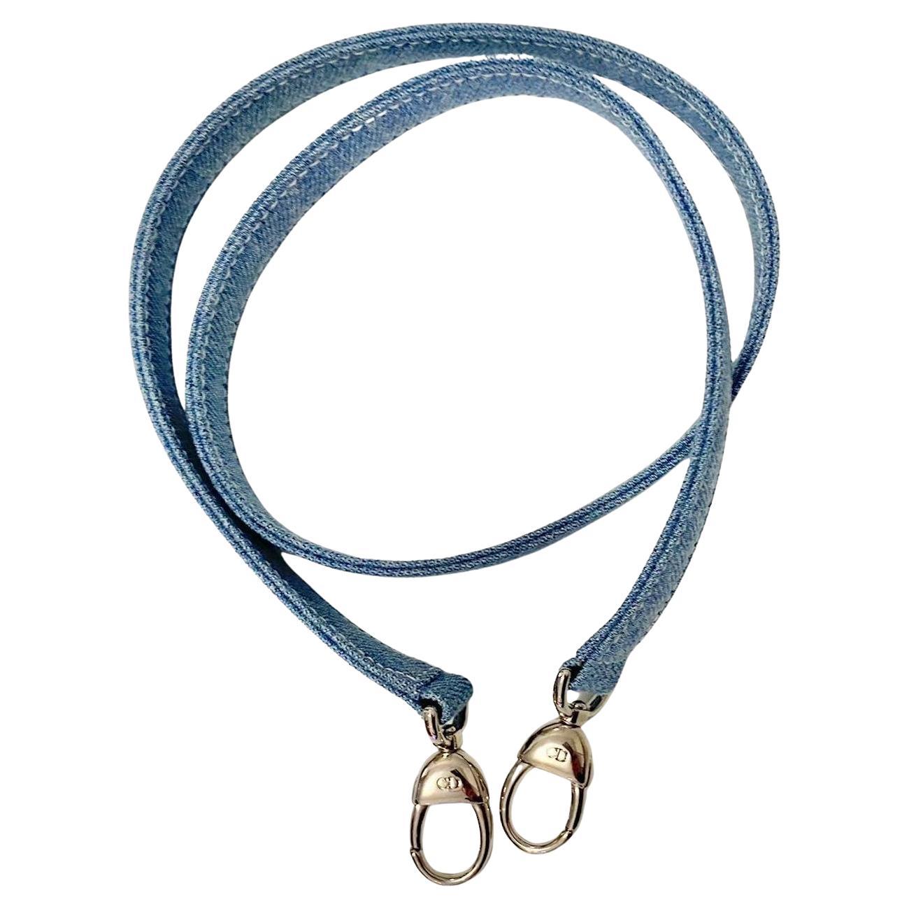Christian Dior's light denim bag strap features durable, shiny silver-toned metal accents stamped CD

Condition: 200os, vintage, like new 

Measurements: 34x0.5in / 90x2cm 