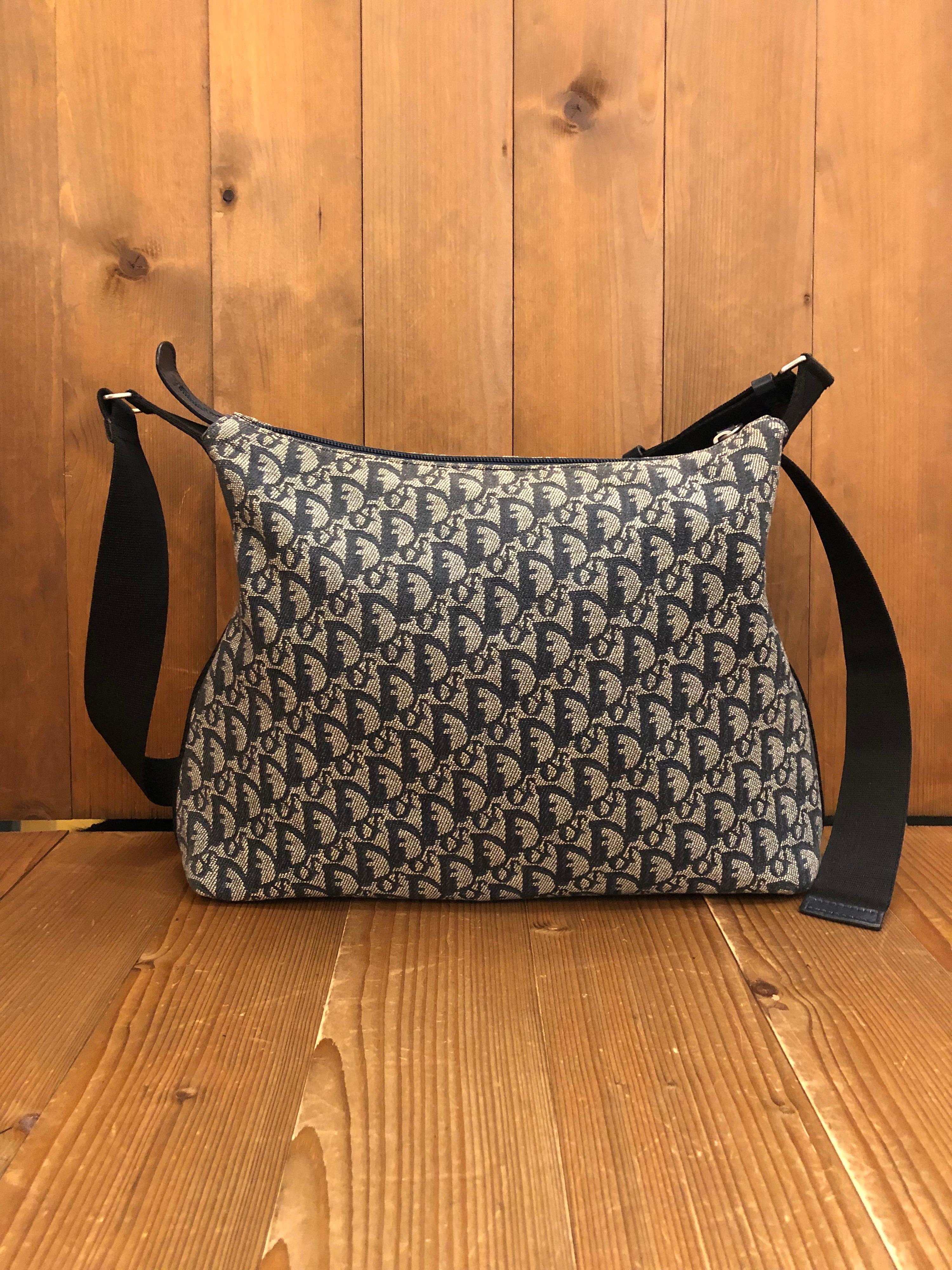 2000s Christian Dior messenger crossbody bag in navy trotter jacquard and leather. Made in Italy. Measures approximately 12 (top) 14 (bottom) x 10.5 x 4 inches Strap drop 26 inches at its longest. Unisex.
 
Condition - Minor signs of wear. Generally