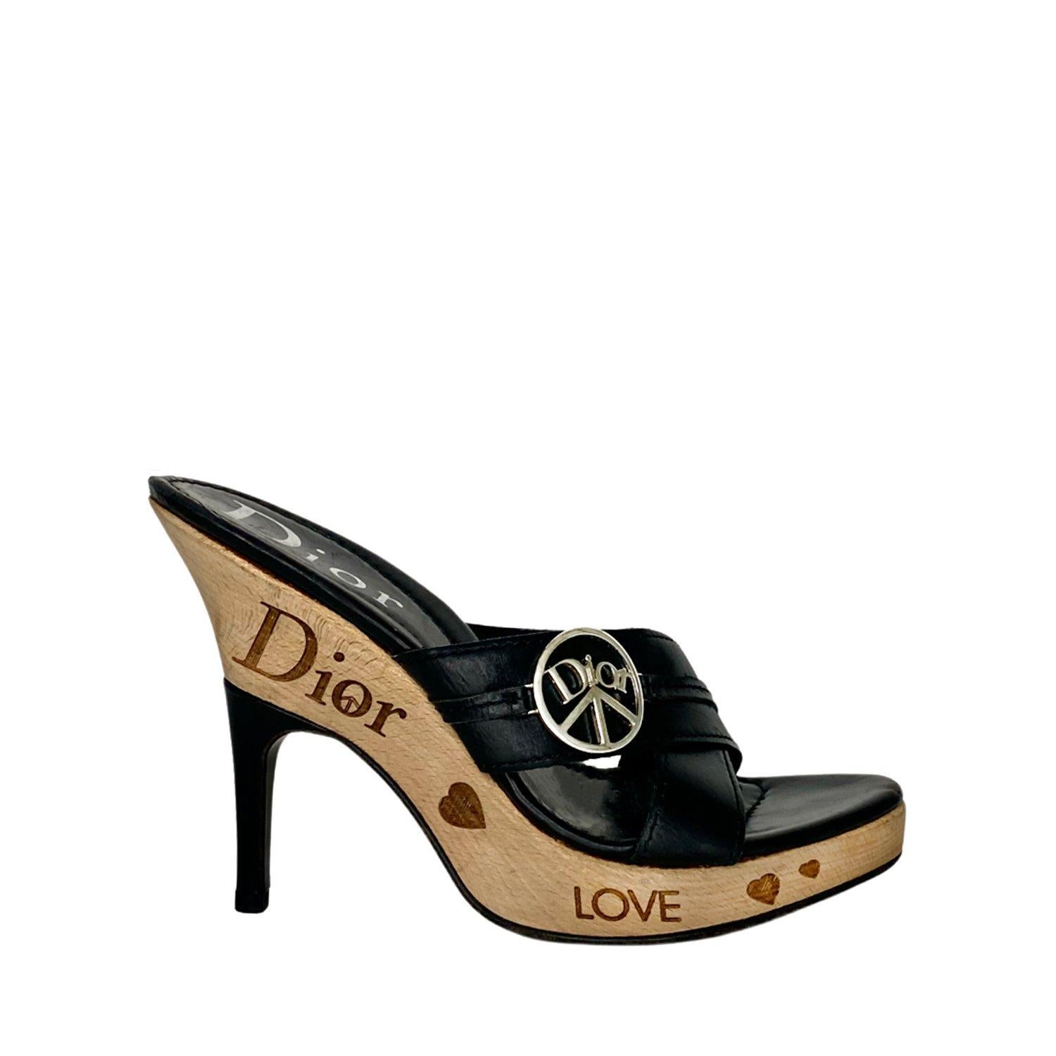 Black and brown leather and wood heel sandals for Christian Dior by John Galliano. Circa early 2000s. Featuring Dior peace embellishments in silver metal to the front, Dior signature logo to the footbed and heart, peace, love and Dior signs imbedded