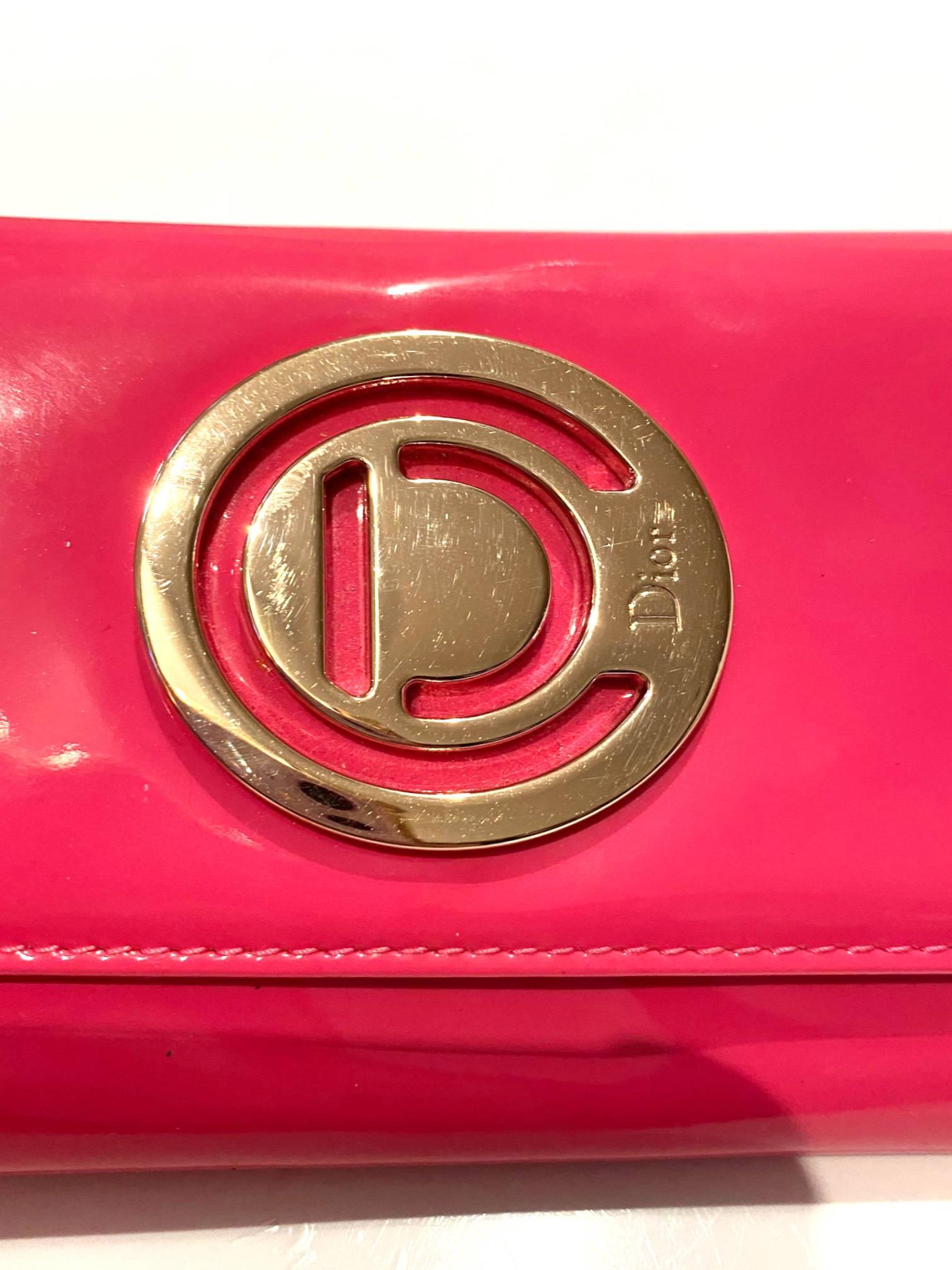 On trend Barbiecore stunning yet practical Christian Dior purse on chain, crafted from fuchsia patent leather, flap secures well with snap fastener, leather-fabric interior, Removable gold chain for carrying or converts to clutch, date code-serial