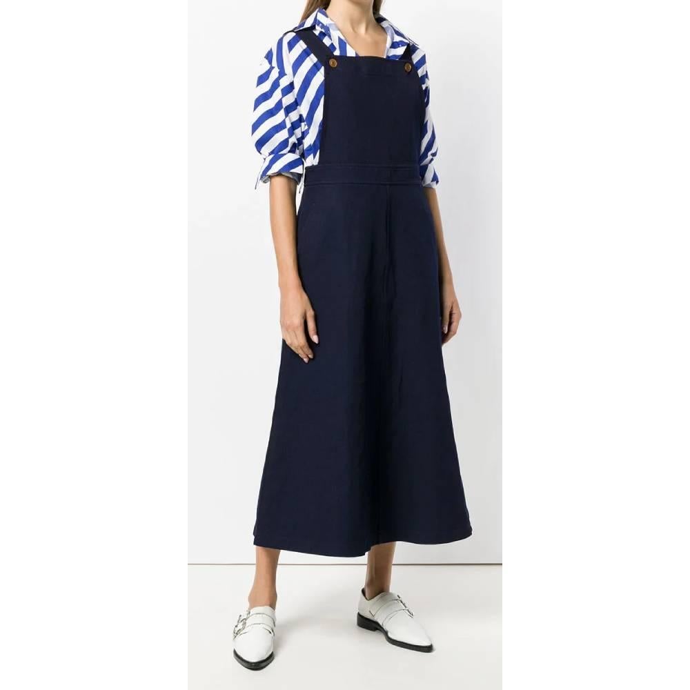 Medium-long Comme Des Garçons blue dress without sleeves, front square neckline with beige buttons and crossed design on the back.

Years: 2000s

Size: M

Linear measures

Height: 130 cm
Waist: 41 cm