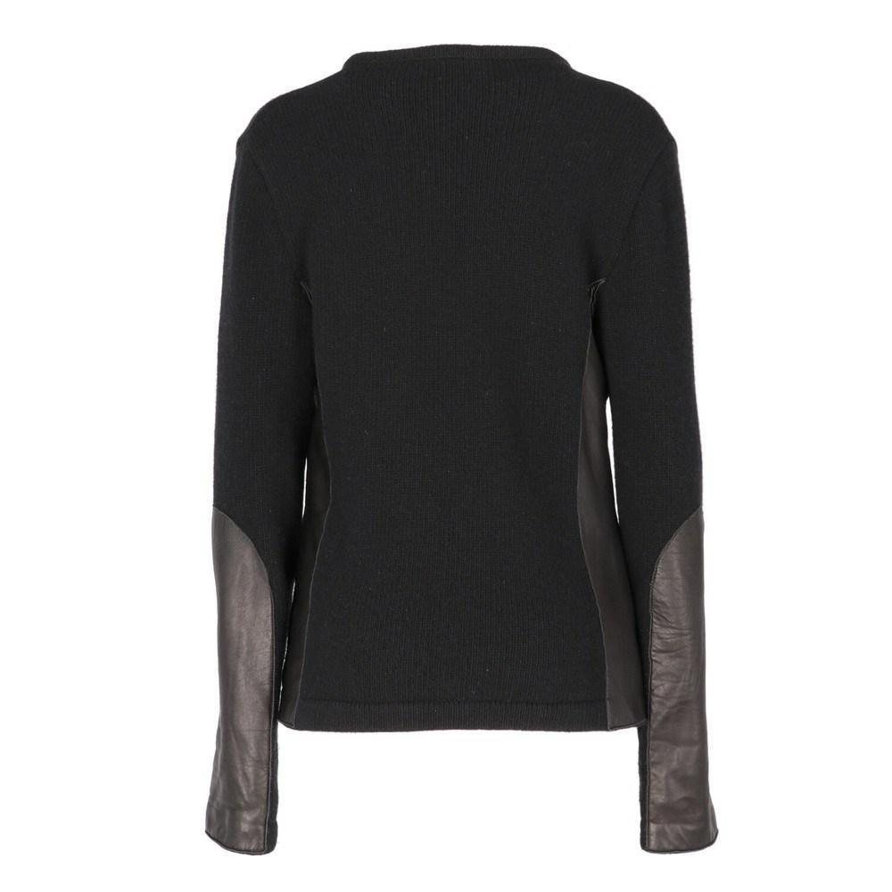 Costume Naional black wool V-neck sweater with faux leather details.

Size: L

Flat measurements
Height: 63 cm
Bust: 47 cm
Shoulders: 47 cm
Sleeves: 66 cm

Composition: 60% Wool - 20% Angora - 20 % Nylon

Made in: Italy

Condition: Very good