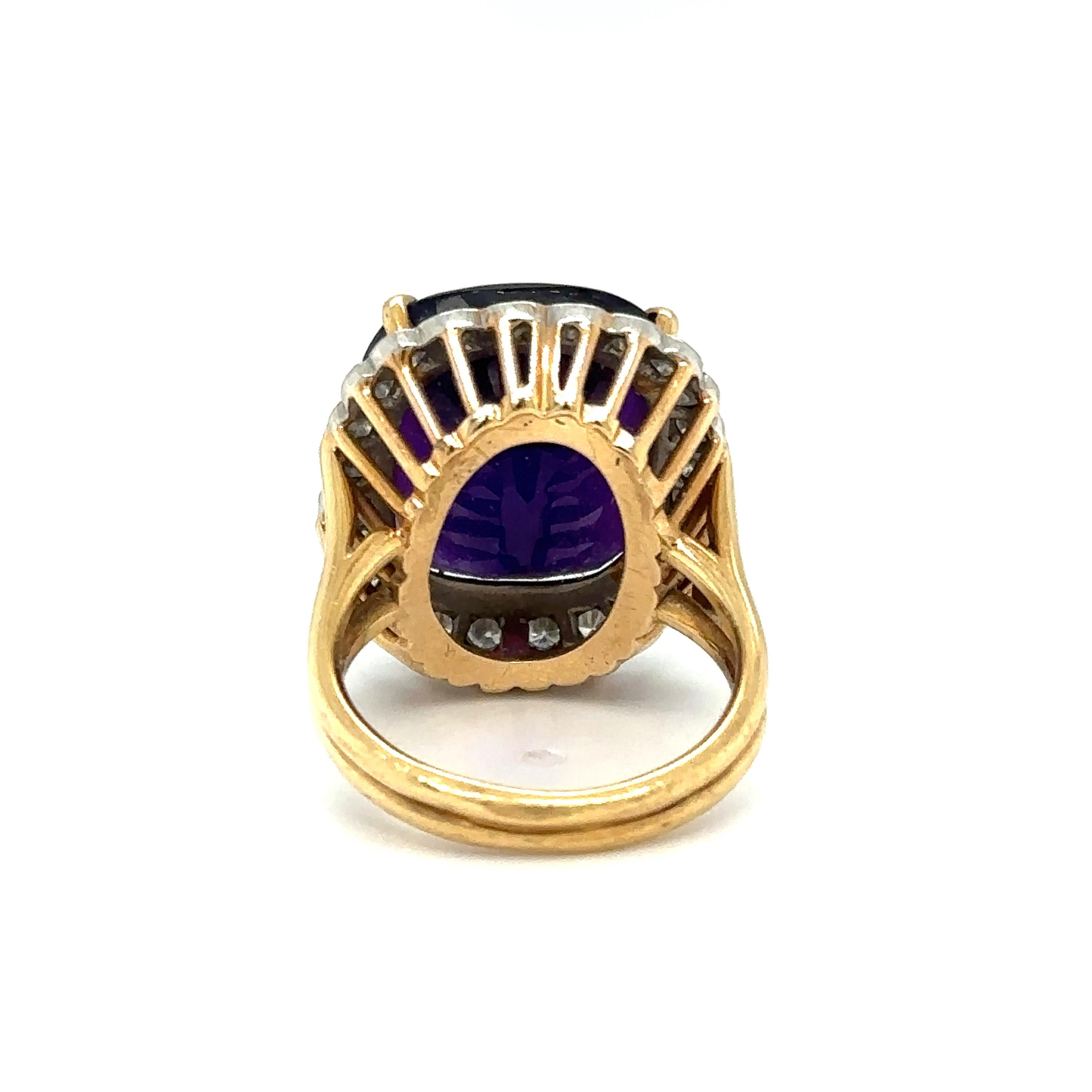 Item Details: This cocktail ring features a center amethyst which is a unique custom checkerboard cut, surrounded by a halo of diamonds. The diamonds are held in white gold prongs, and the amethyst is held in a 4-prong talon prong setting, crafted