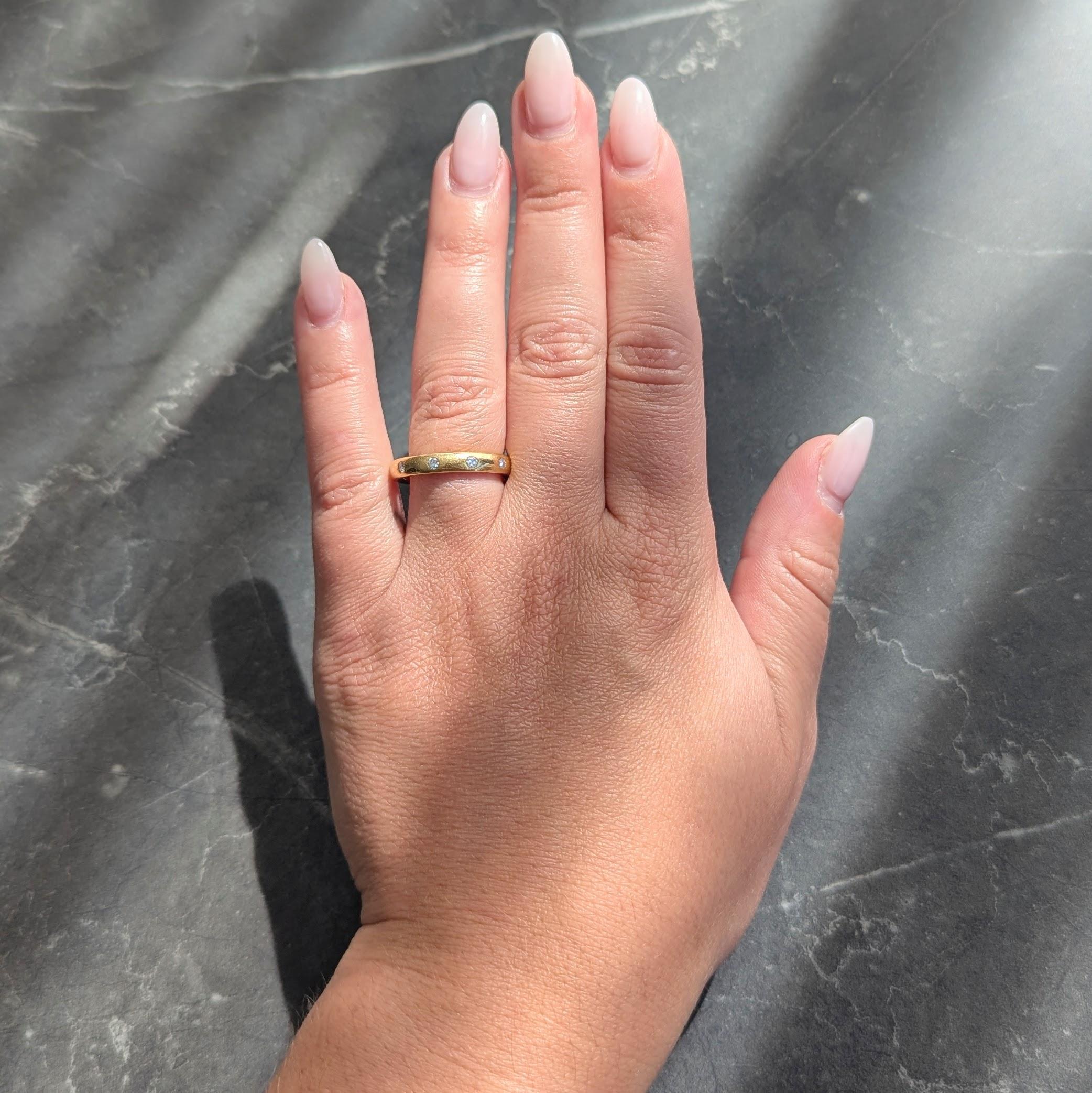 Designed as a rounded band flush set with diamonds throughout
Round brilliant cut and weighing approximately 0.40 carats total
G/H color with VS2 clarity
Stamped for 18 karat gold
With maker's mark
Circa: 2000s
Ring size: 6 1/2 and sizable
Measures