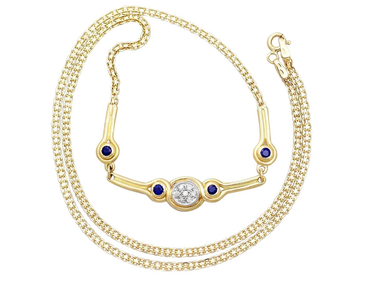 A fine contemporary 0.15 carat diamond and 0.10 carat sapphire, 18 karat yellow gold necklace; part of our contemporary and estate jewelry collections.

This fine contemporary diamond and sapphire necklace has been crafted in 18k yellow gold with an