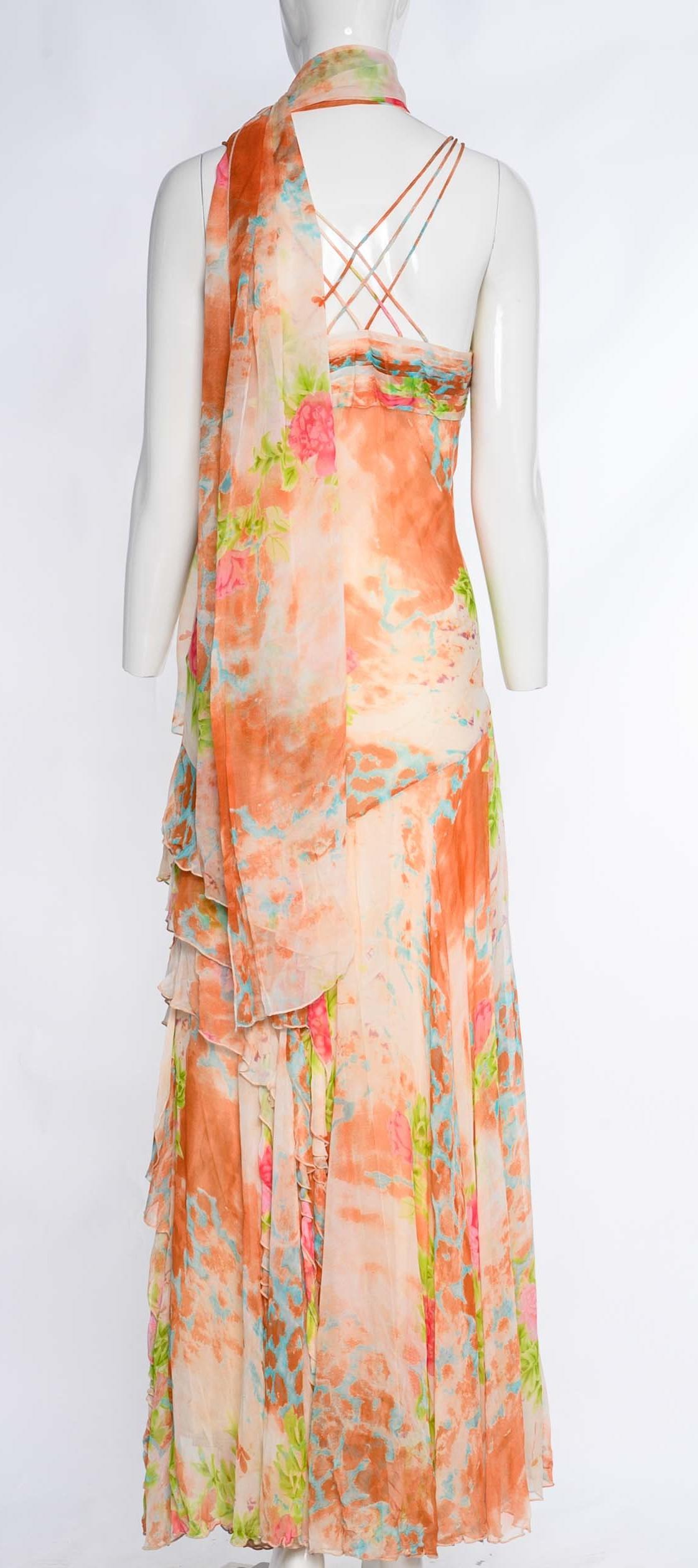 The vintage Diane Freis dress is a captivating piece crafted from silk, featuring a vibrant marmalade orange and blue leopard pattern complemented by delicate pink floral accents and exquisite hand-beaded embellishments.

The sweetheart neckline and