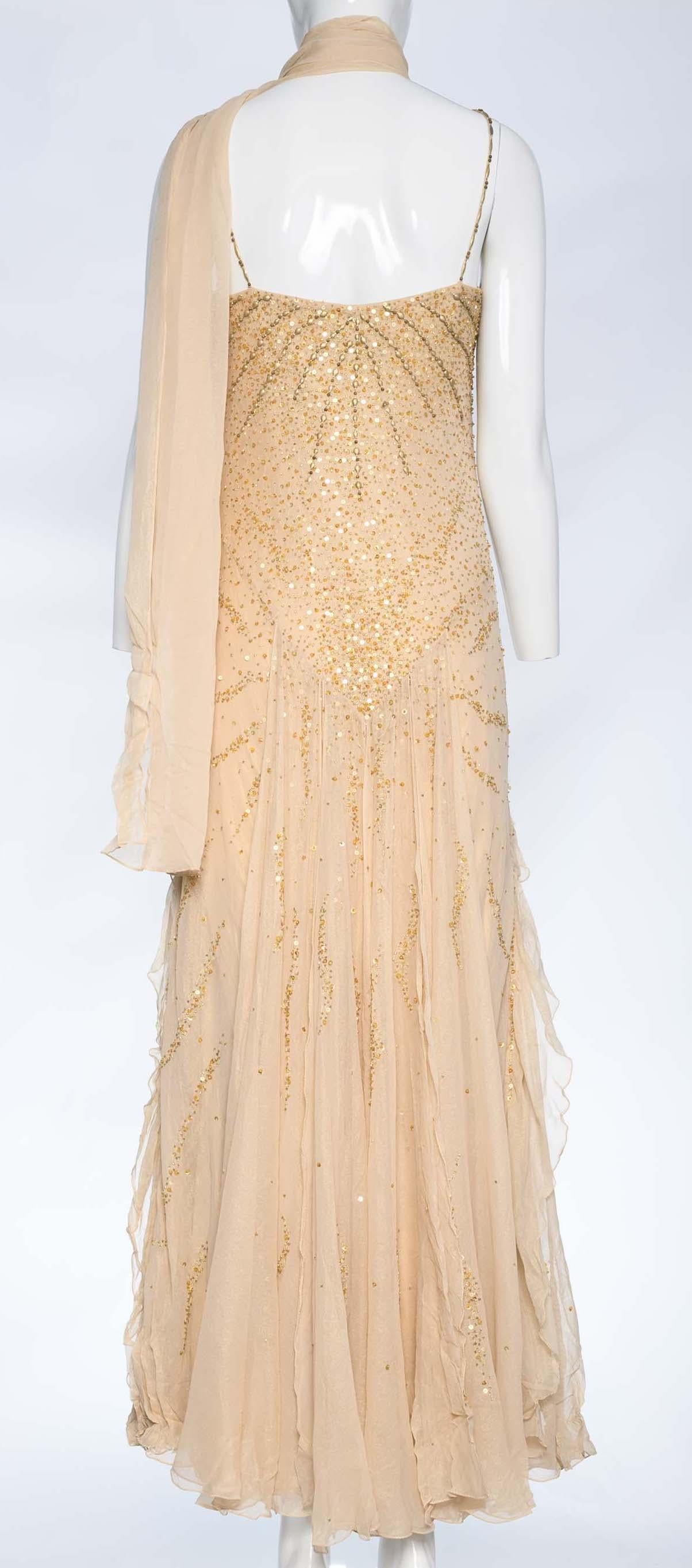 Crafted from light beige silk fabric, this dress emanates elegance and sophistication. The dress is adorned with tonal sequin and hand bead details, showcasing intricate craftsmanship and lending a sparkling allure to the overall design. These