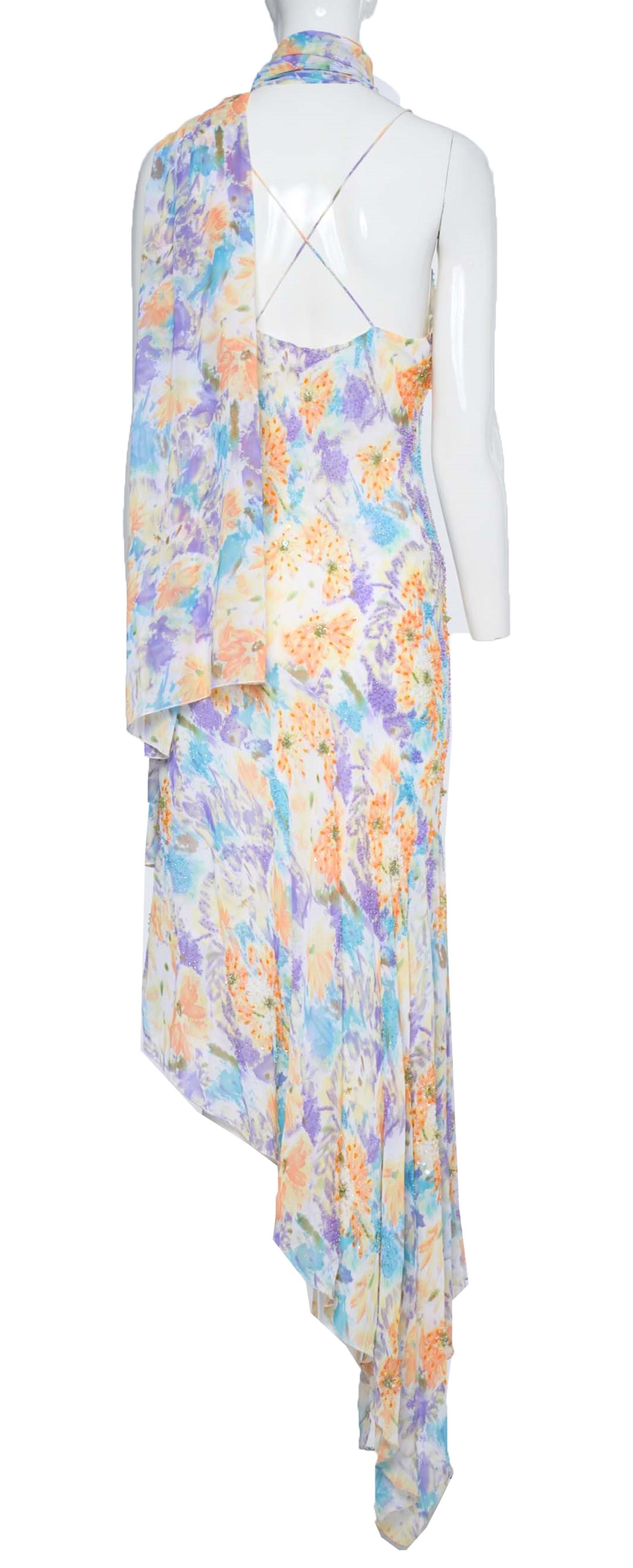 This vintage Diane Freis dress, with its stunning purple, blue, and orange floral print on an ivory background, is perfect for a variety of occasions. Whether you're attending a cocktail party or a summer wedding as a guest, this dress will help you