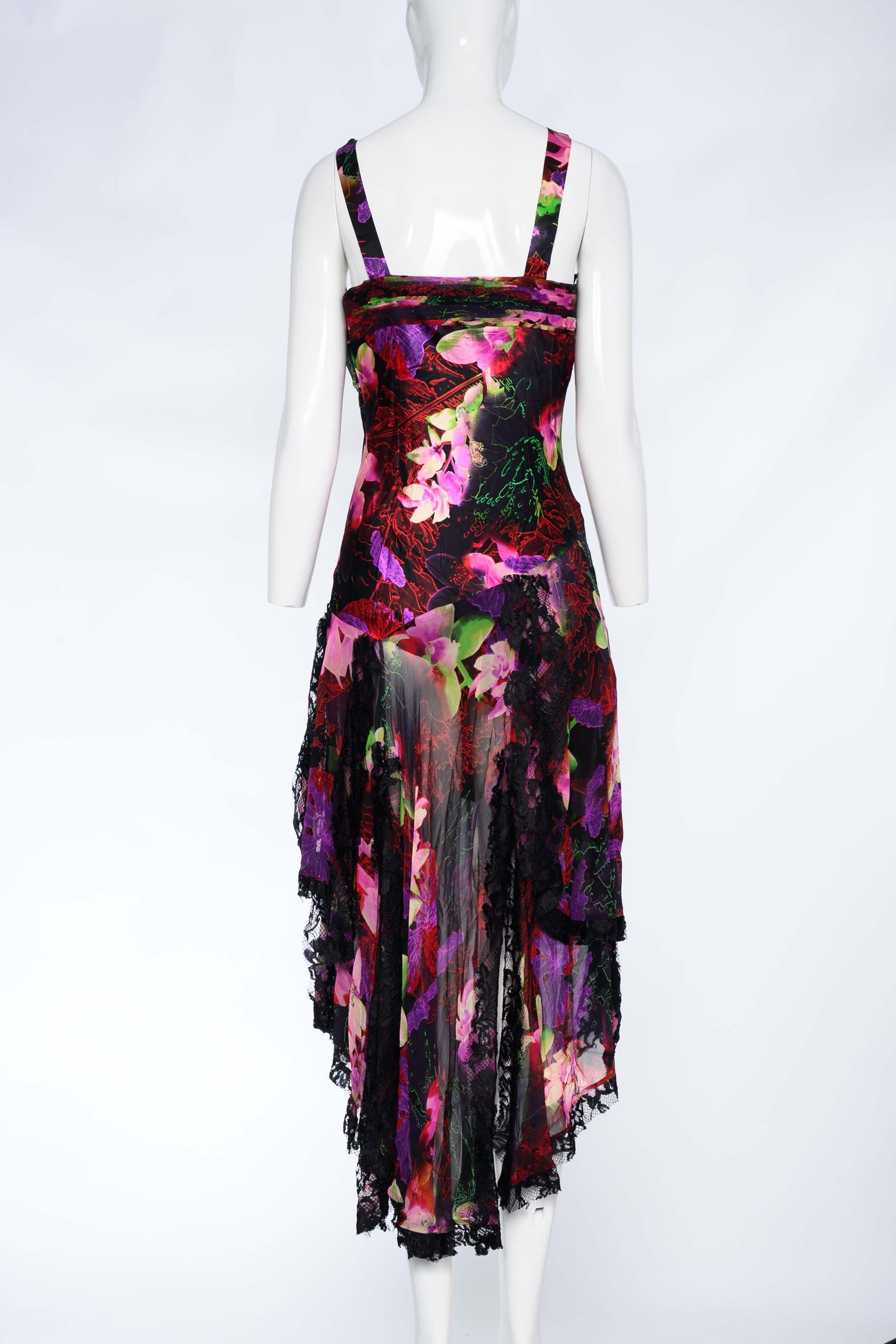 This Diane Freis silk blend evening dress is a stunning piece of art that will make you stand out at any formal occasion. The dress features a colorful floral print with a black lace trim, a halter neckline with a crisscross strap design, and a