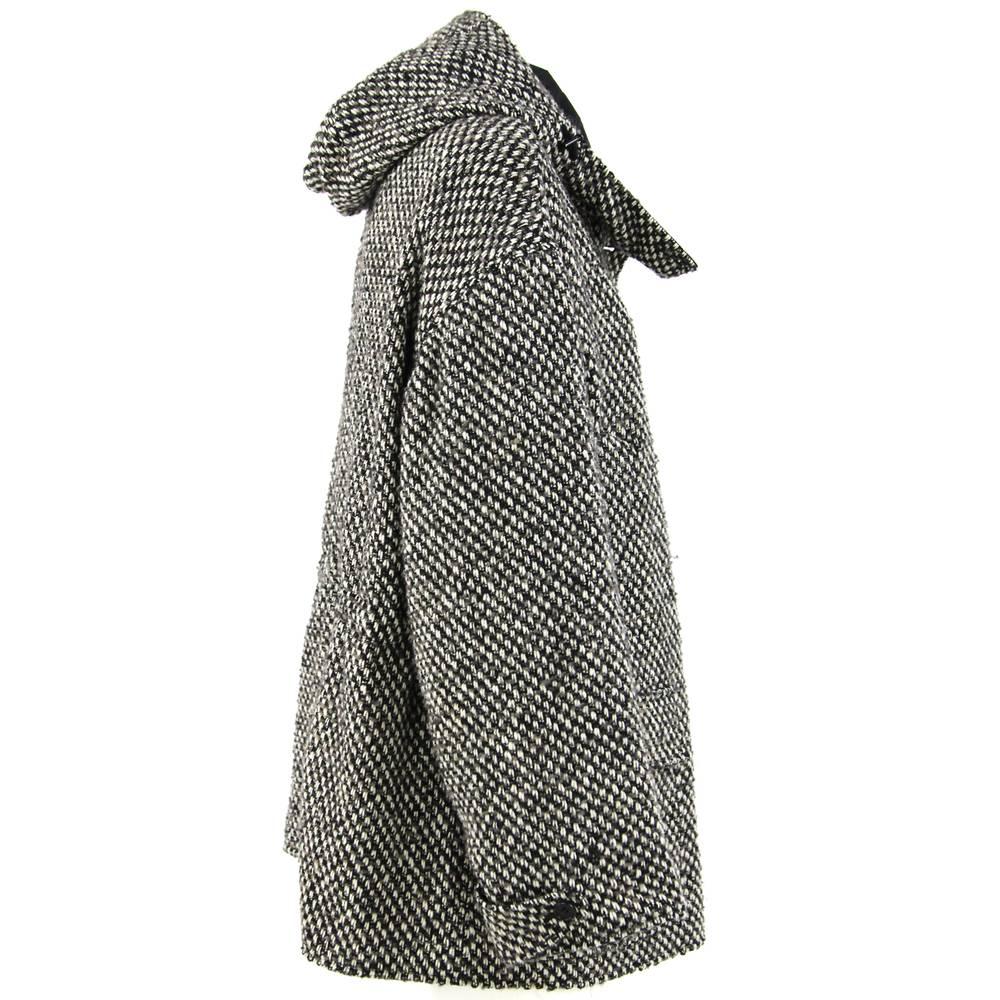 DKNY white, black and grey bouclé wool coat. Hooded model, featuring drawstring at the waist, slightly off-center concealed zip and button fastening, two welt pockets and two patch pockets. Slightly oversize fit.

Made in China
Years: 2000s

Size: