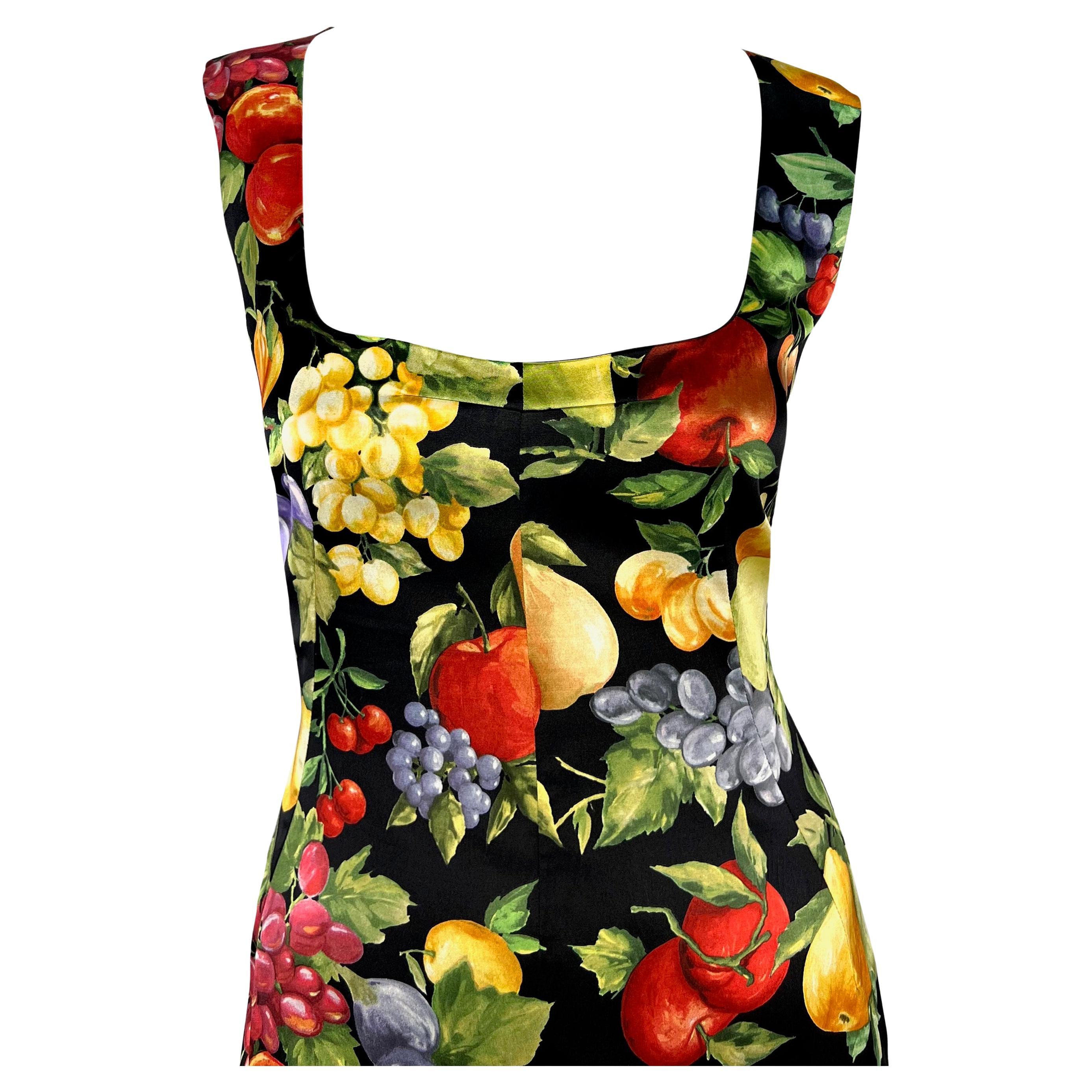 This knee-length Dolce & Gabbana dress, crafted from luxurious satin, bursts with vibrancy with its lively fruit-motif print. Designed with stretch fabric, it hugs the body with a form-fitting silhouette. The dress is distinguished by its low 
