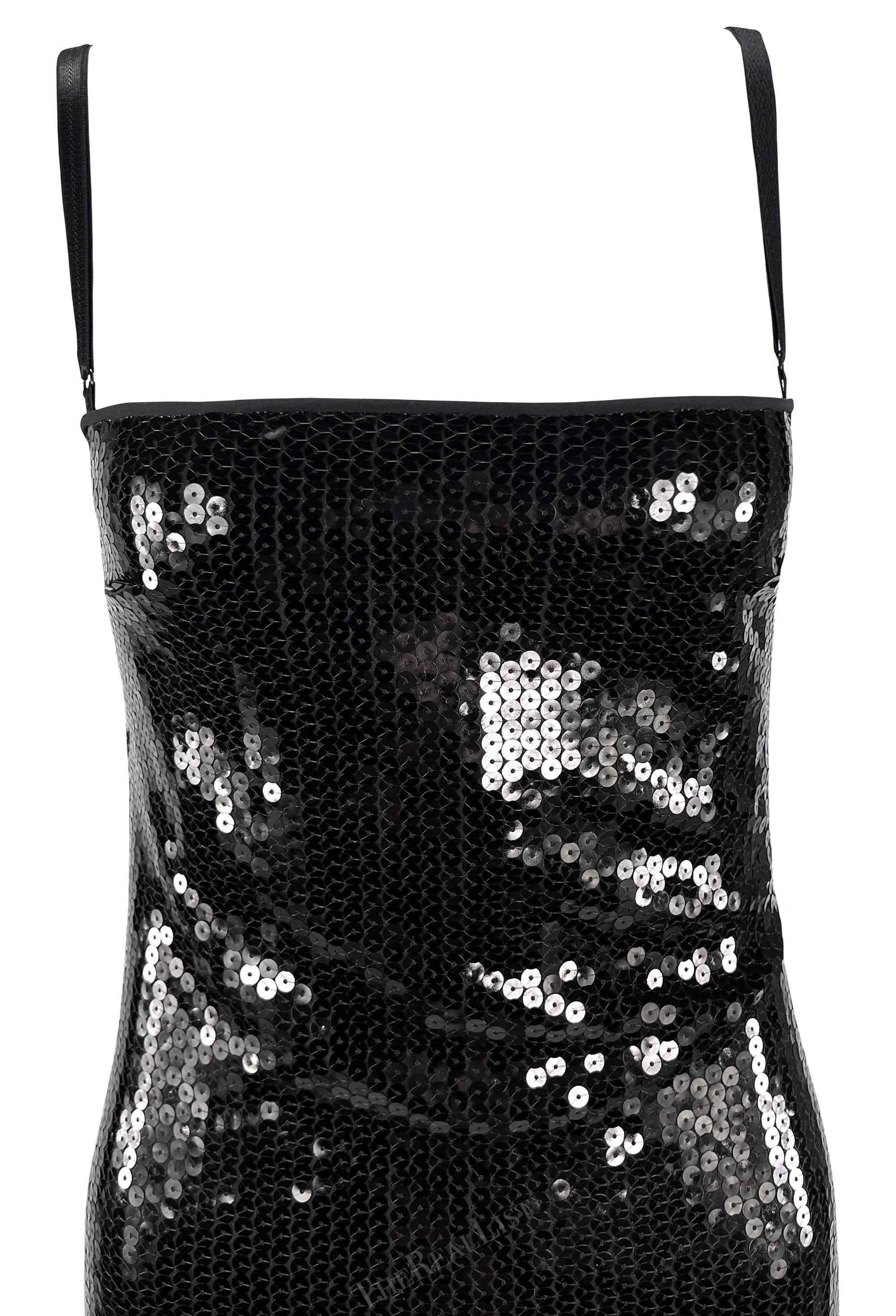 A fabulous black sequin Dolce & Gabbana mini dress from the early 2000s. This stunning, form-fitting dress is entirely adorned with shiny black sequins. The dress features adjustable bra-style straps and a square neckline. Perfect for a night out or