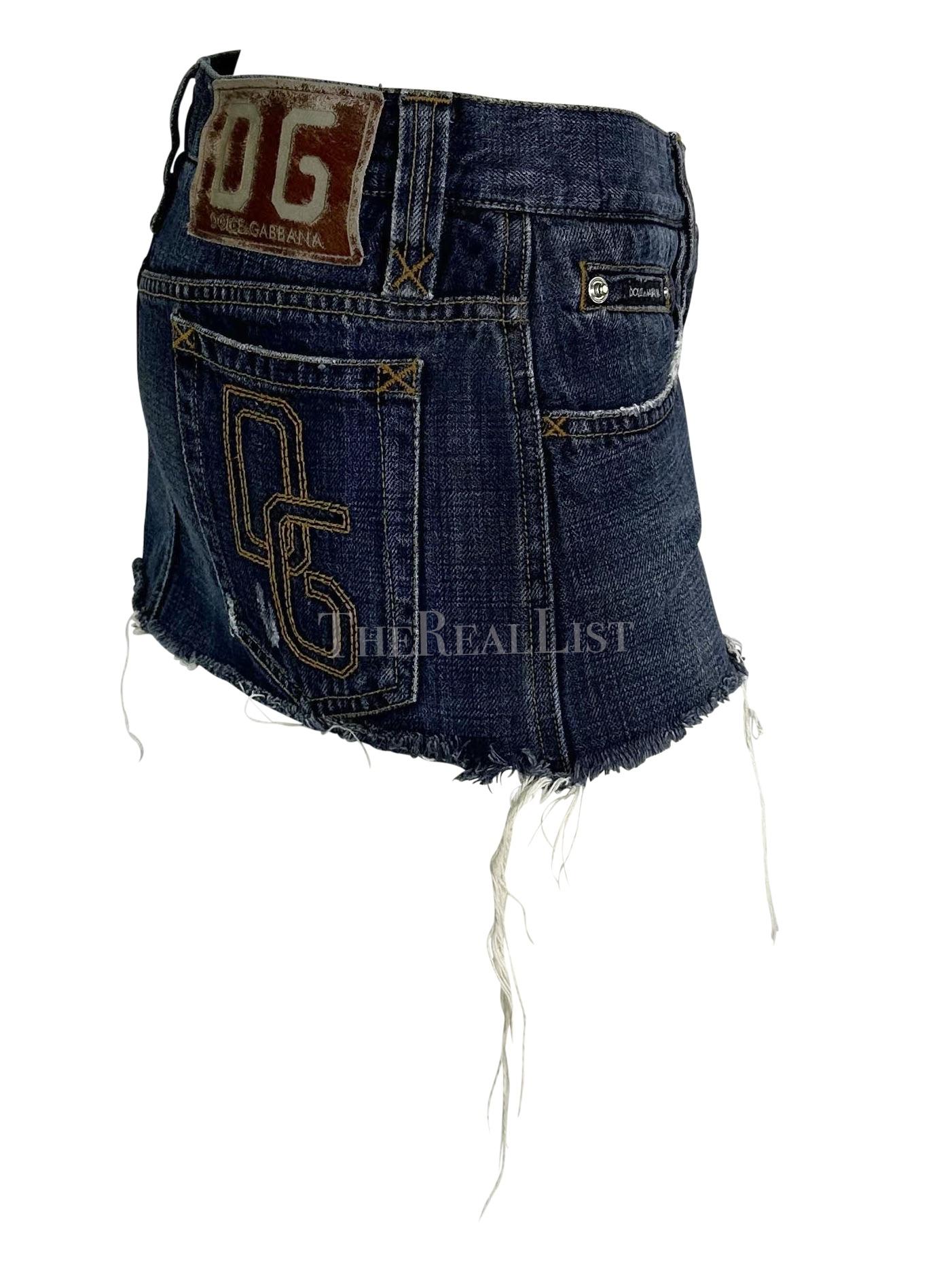 Presenting a hot denim Dolce and Gabbana super mini jean skirt. From the early 2000s, this short skirt is constructed of denim and features a distressed hemline, 'DG' embroidered on the back pocket, and a pony hair jacron. The perfect Y2K piece,