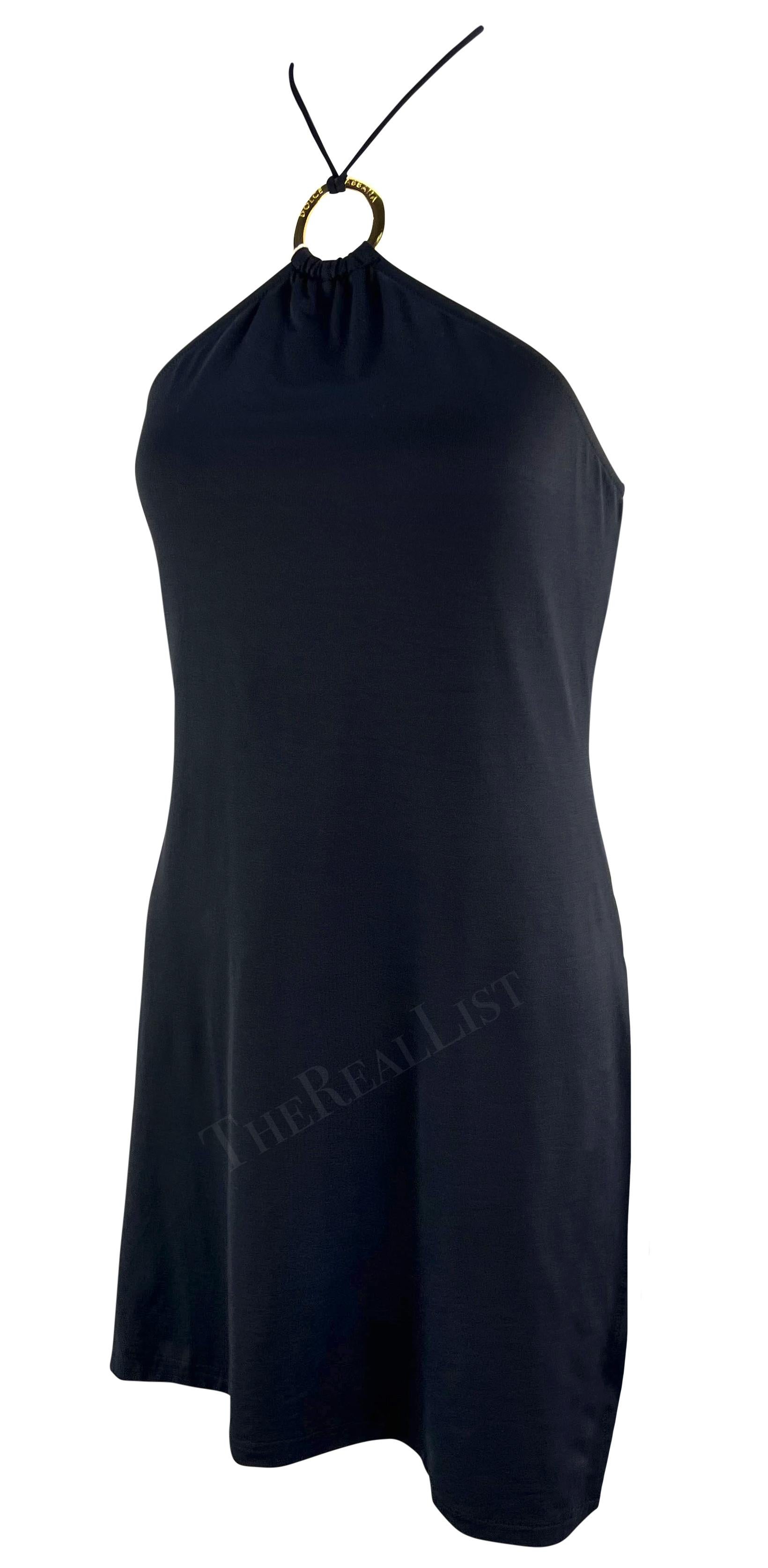 From the early 2000s, this fabulous black stretch Dolce & Gabbana halterneck mini dress prominently features a gold-tone metal ring above the bust. This branded metal accent connects to the halterneck tie. This knock out Dolce & Gabbana Mare dress