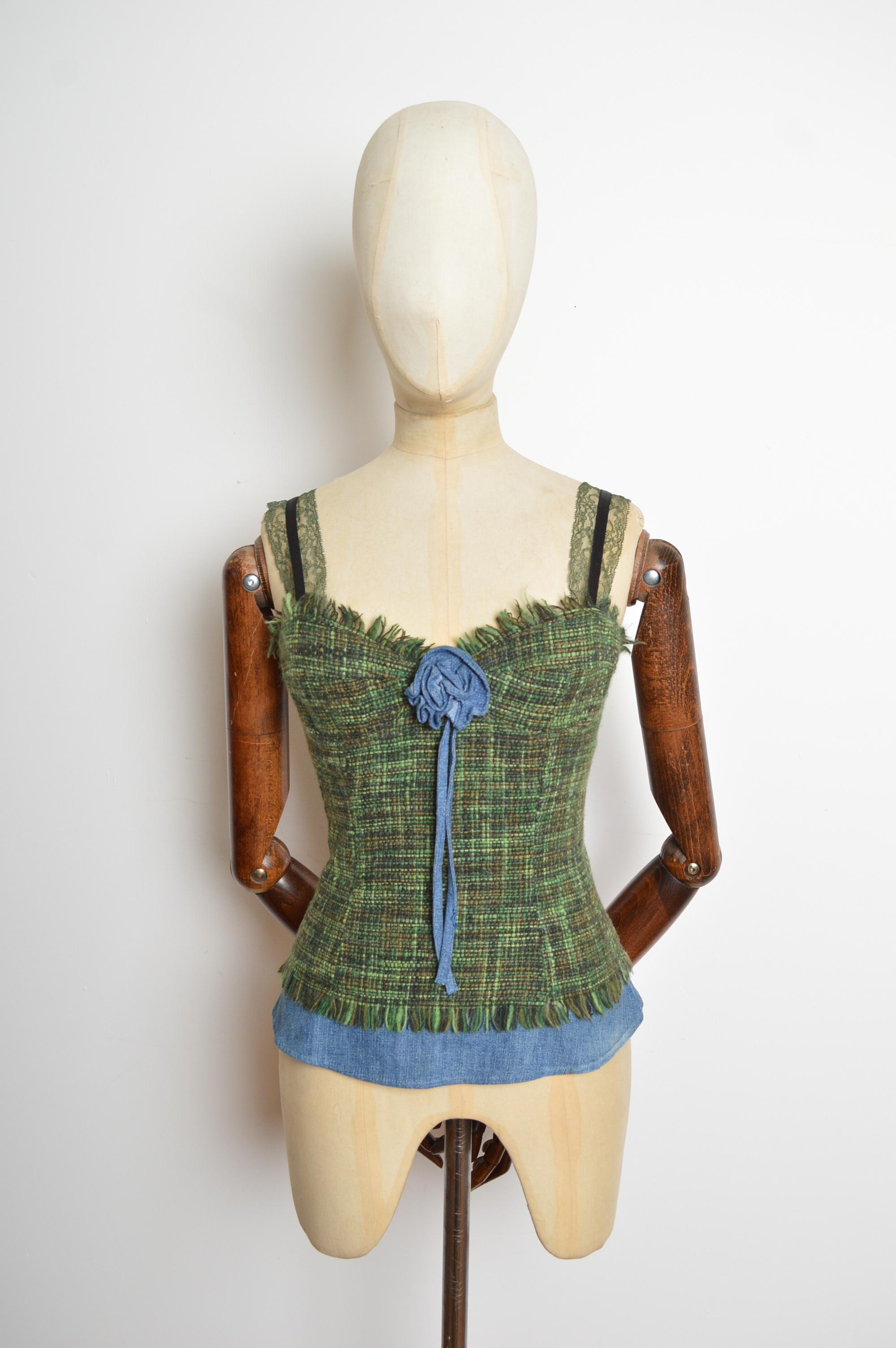 Un favoloso bustier di Dolce & Gabbana degli anni 2000. Realizzato in tweed verde con accenti denim e corpetto floreale. Il bustier si chiude con una cerniera posteriore nascosta e presenta spalline in pizzo decorate. Completamente foderato in