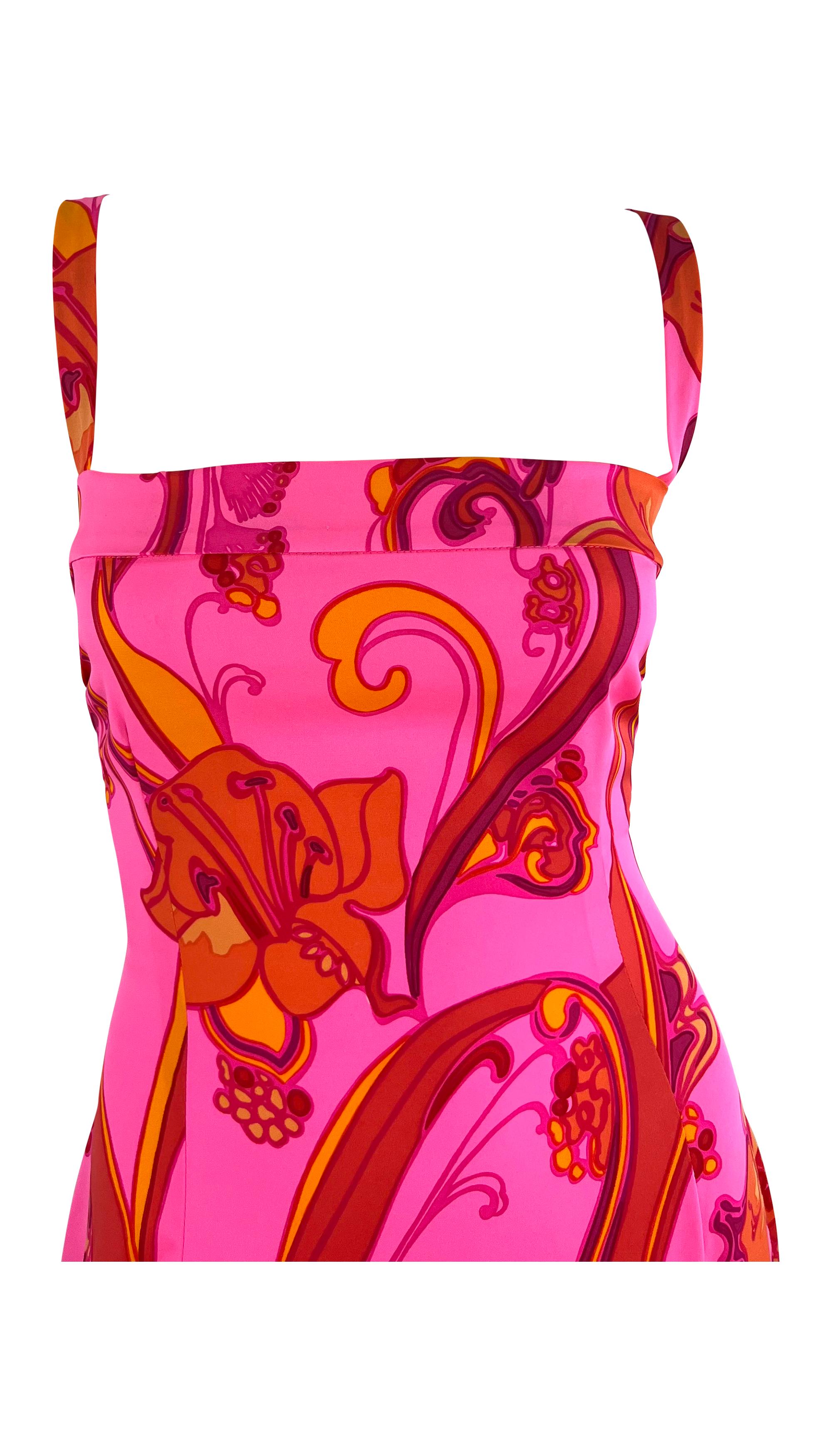 From the early 2000s, this bright pink Dolce and Gabbana dress is covered in a bold, groovy hibiscus floral design. This stretchy, form-fitting dress is complete thin shoulder straps and a square neckline. 

Approximate measurements:
Size -