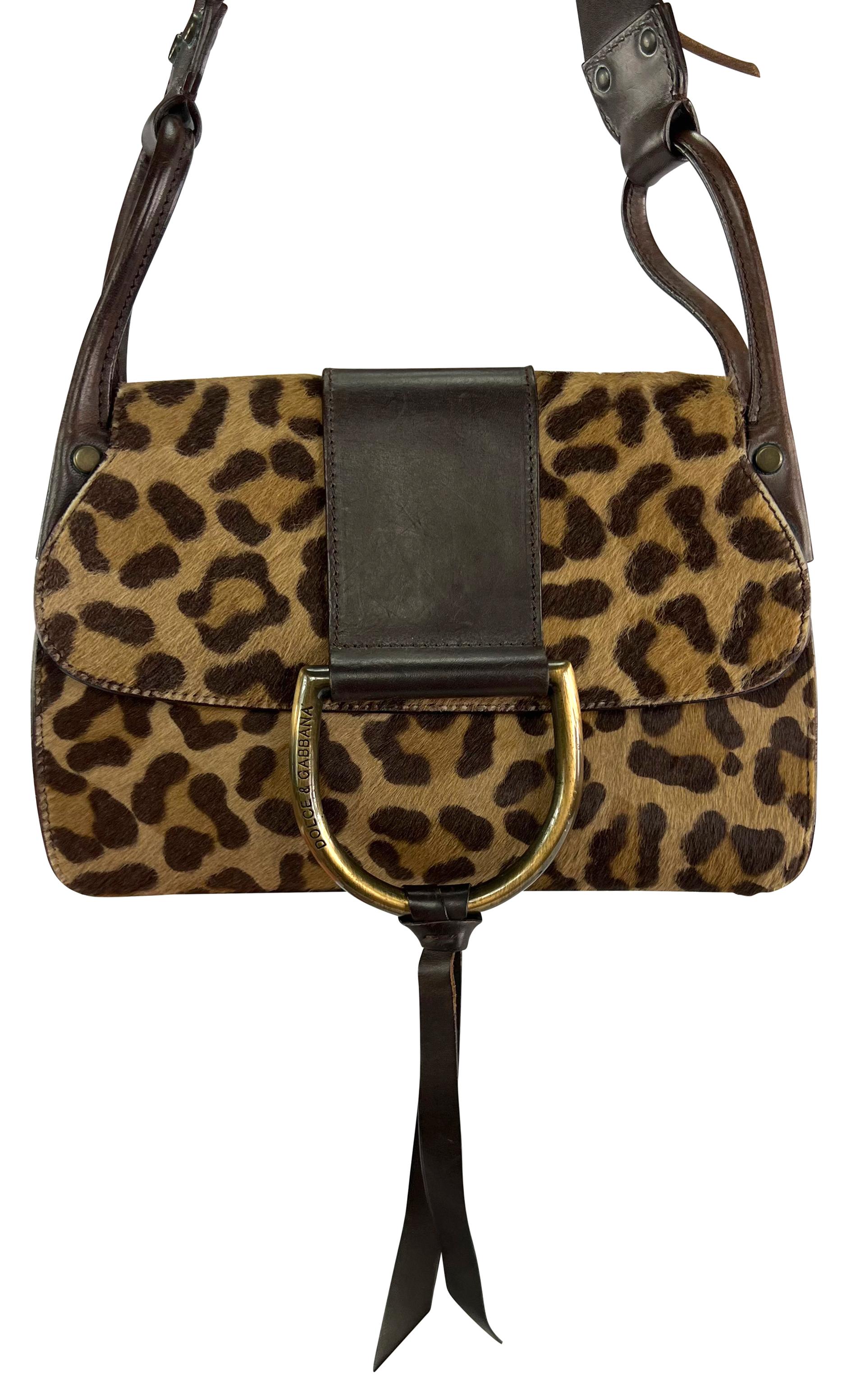 From the early 2000s, this leopard print pony hair Dolce & Gabbana bag is the ultimate bold accessory. Constructed of dark brown leather and leopard print pony hair, this flap shoulder bag is complete with a large brass ring at the closure and a