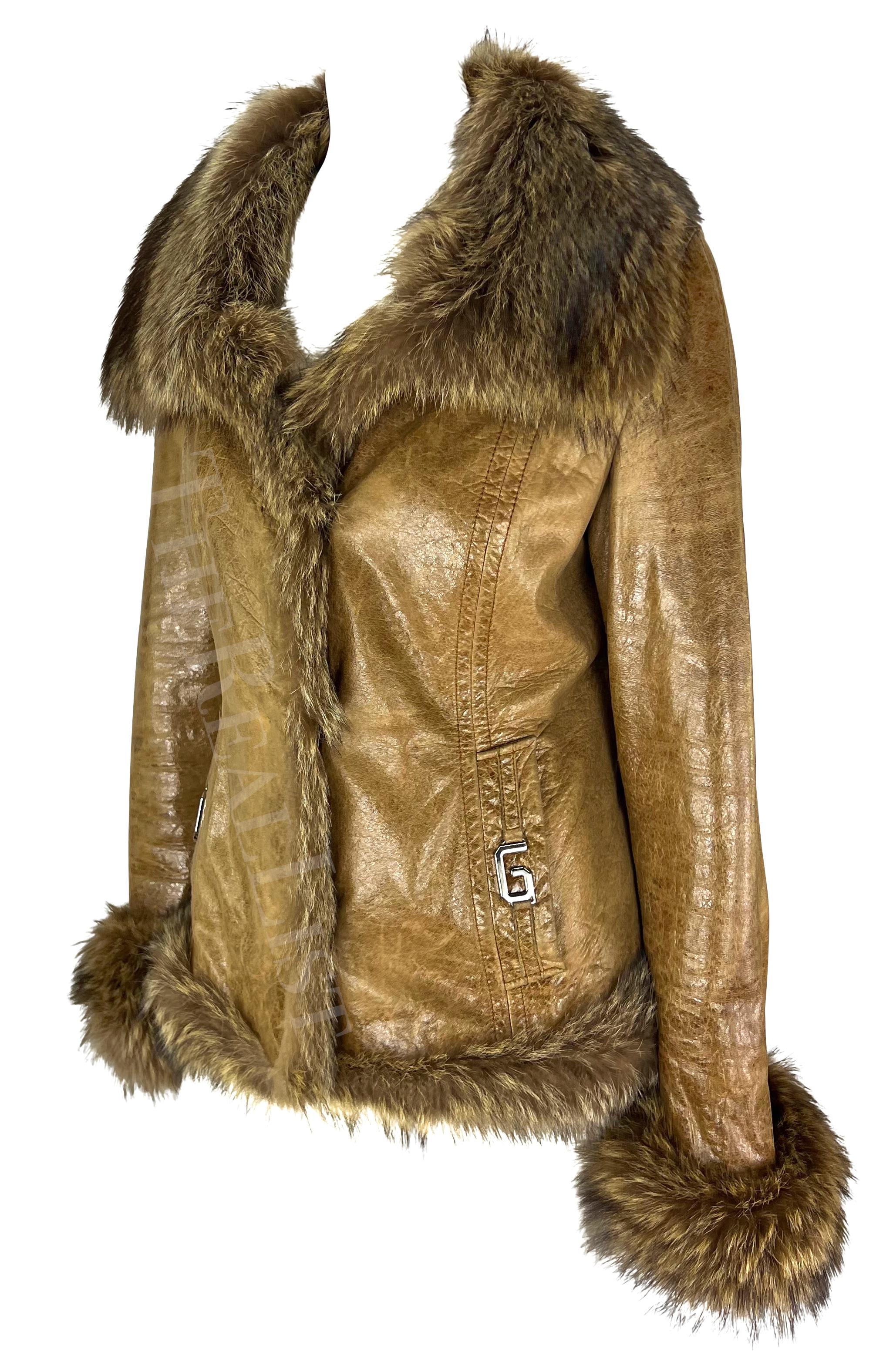 Presenting a fabulous brown Dolce & Gabbana leather coat. From the 2000s, this chic coat is constructed of lightly distressed shiny leather and is made complete with fur trim at the collar, hem, and cuffs. Accented with a silver-tone 'D' and 'G' at