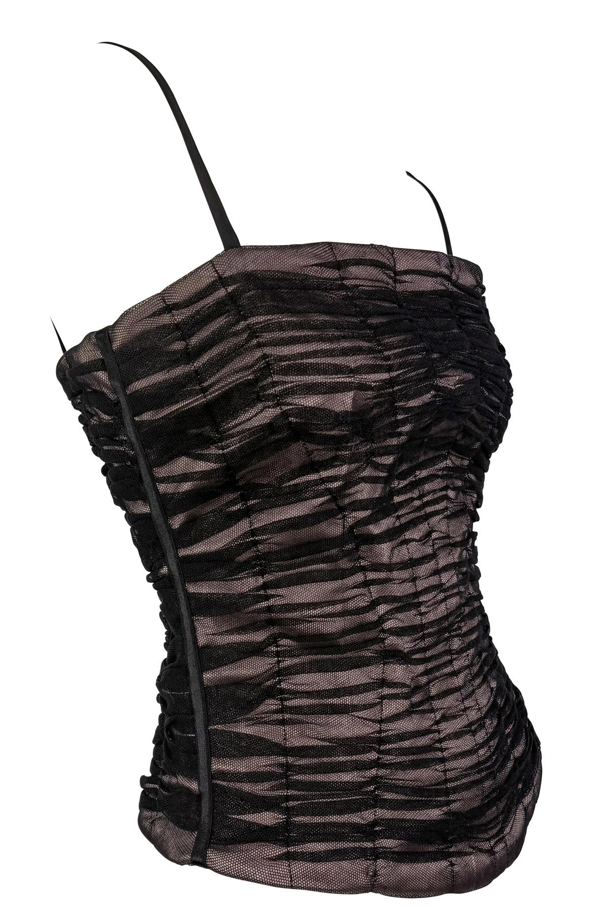 From the 2000s, this Dolce & Gabbana bustier top features a pale pink satin base overlaid with ruched black mesh. Designed with internal boning for structure and thin shoulder straps, the corset-style top is a Y2K must-have. 

Approximate