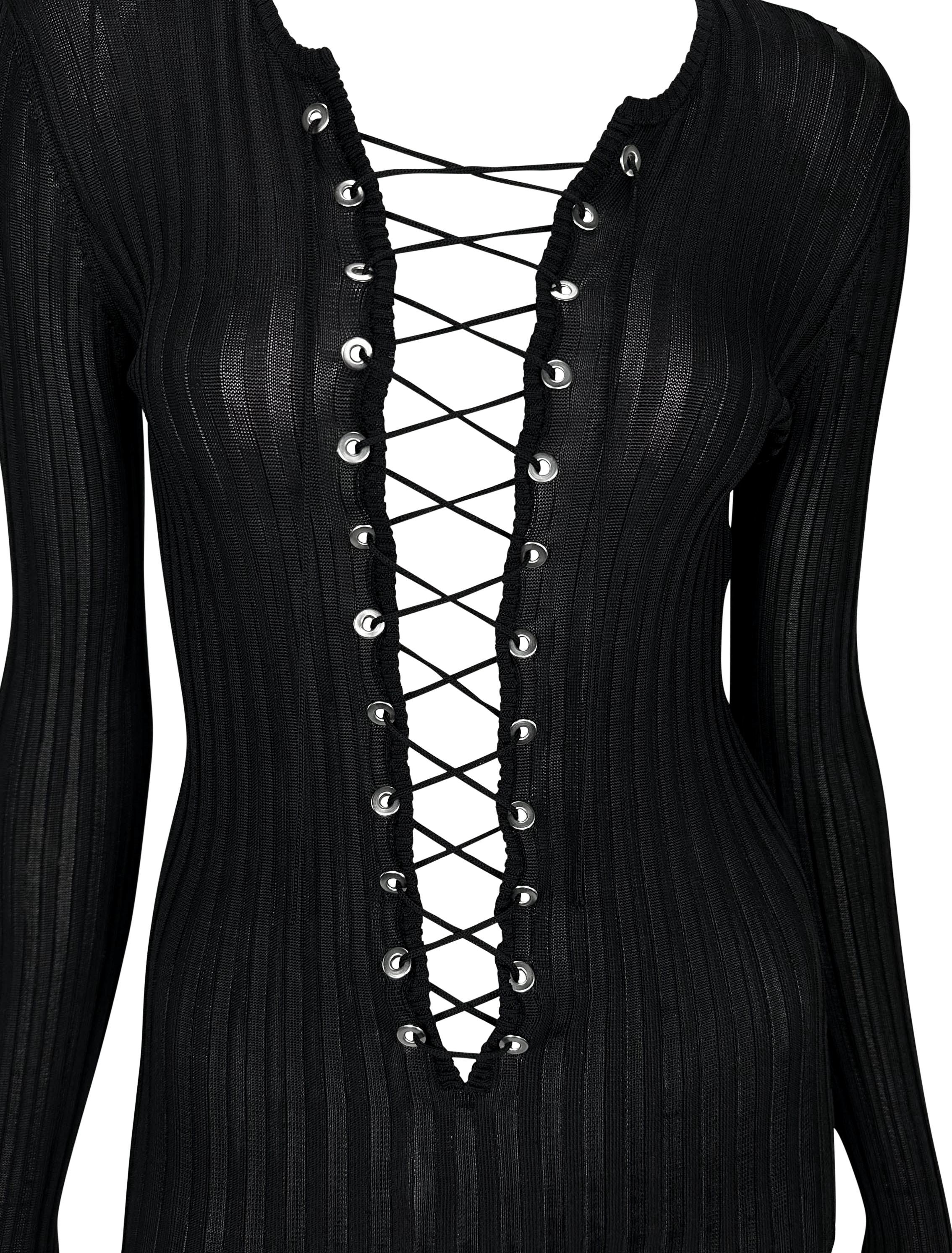 An incredibly stylish Dolce and Gabbana knit long-sleeve top from the early 2000s. This sheer knit design boasts a plunging neckline enhanced by a corset-style lace-up detail. Elevate your wardrobe with this fabulous piece!

Approximate