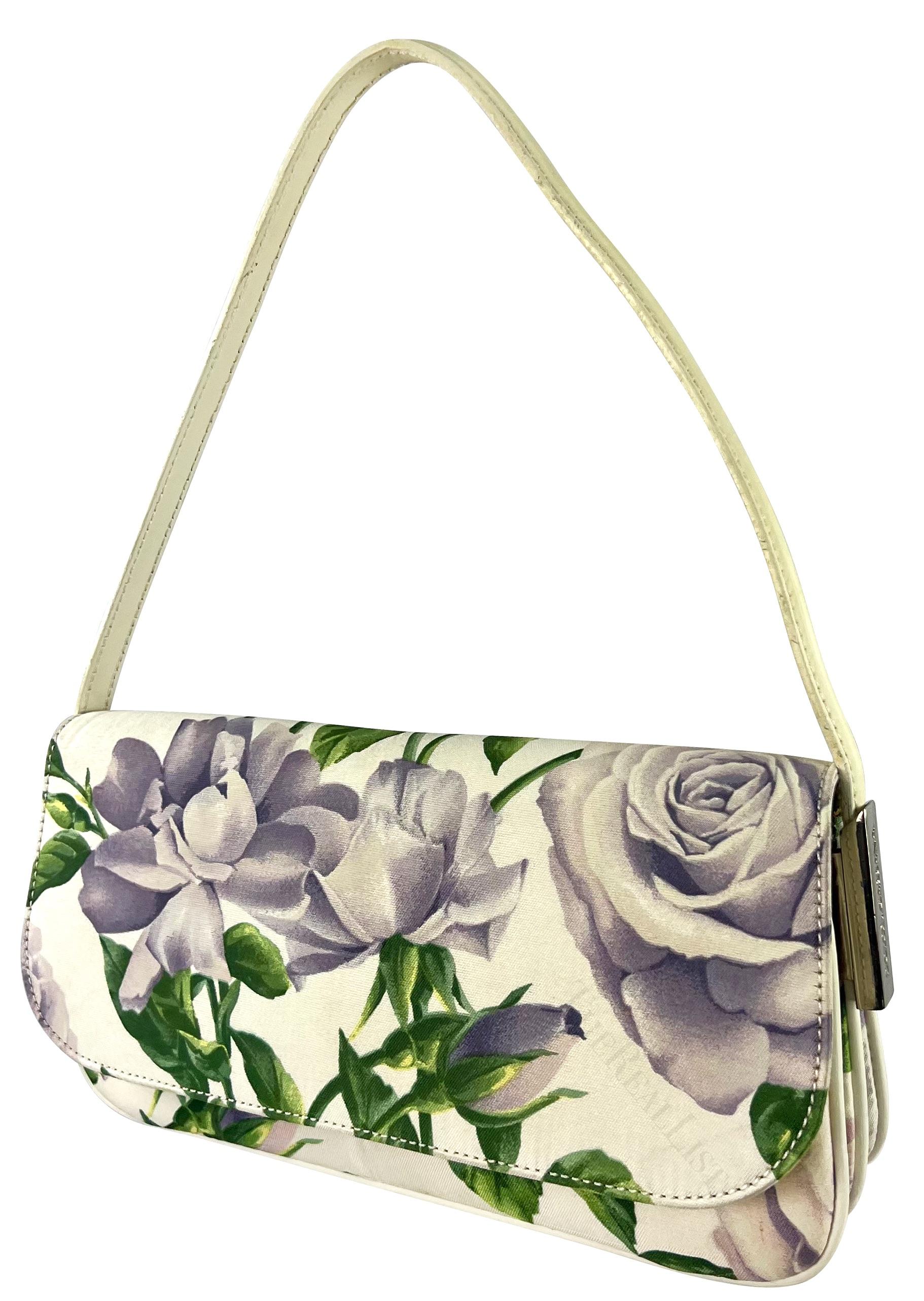 Presenting a fabulous purple rose floral Dolce & Gabbana flap shoulder bag. Elevate your style with this exquisite blue floral Dolce & Gabbana flap shoulder bag, a fashion-forward piece from the late 1990s / early 2000s. Effortlessly embodying