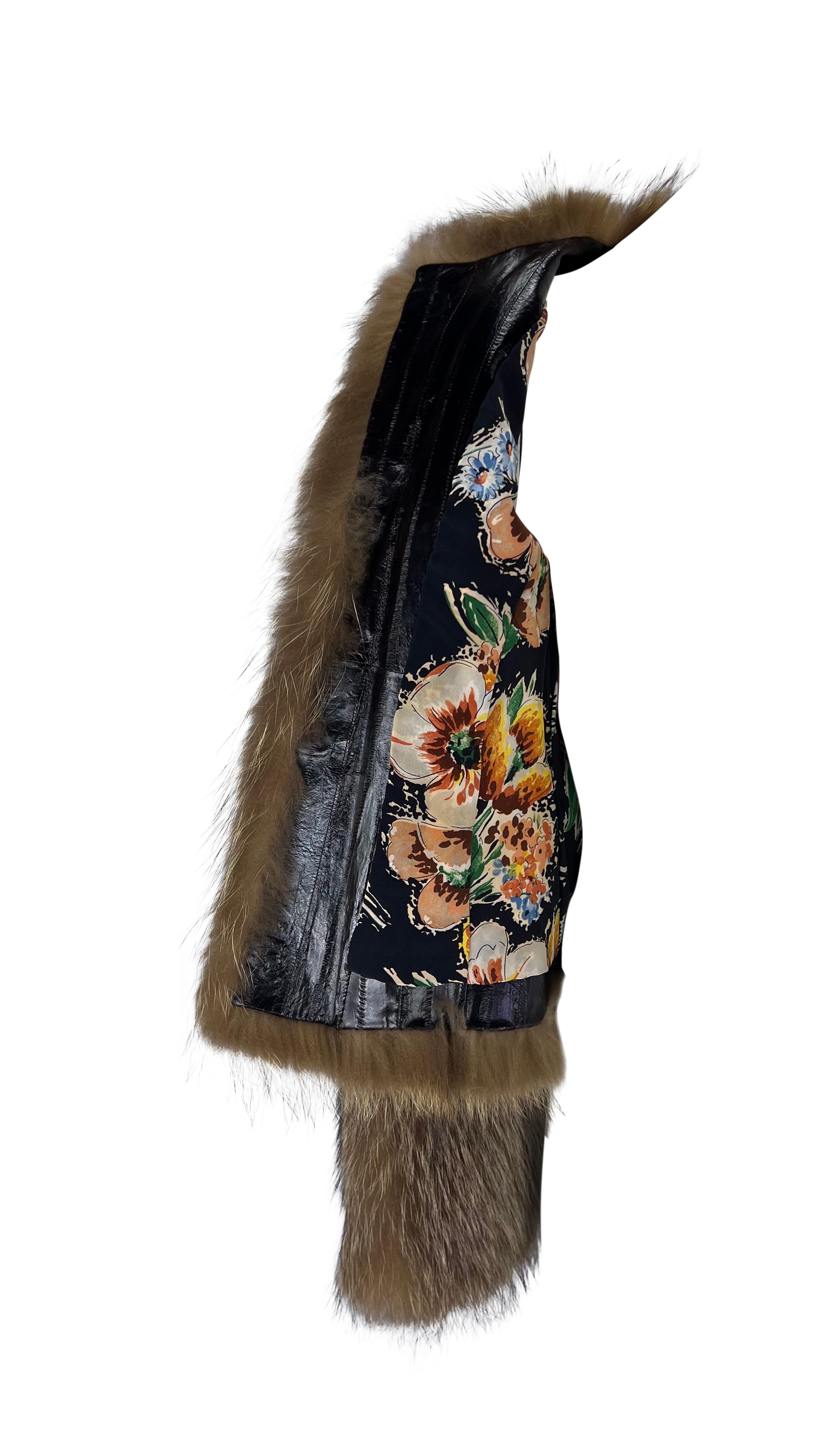 Presenting an incredible raccoon fur Dolce & Gabbana coat. From the early 2000s, this fabulous chubby-style coat is constructed entirely of brown raccoon fur and is made complete with floral silk and deep burgundy eel lining. The coat features a