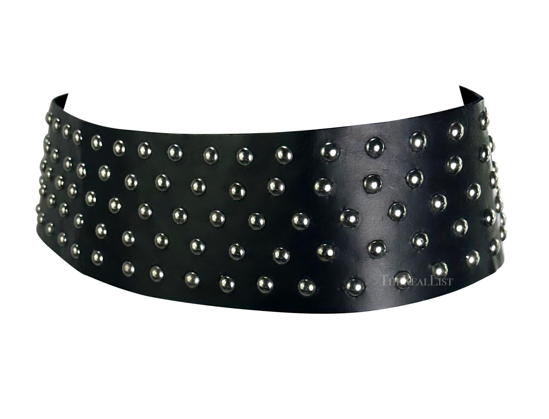 Presenting a wide black Dolce and Gabbana belt. From the early 2000s, this belt is covered in gunmetal studs and features a velcro closure.

Approximate measurements:
Size - IT42
3.5