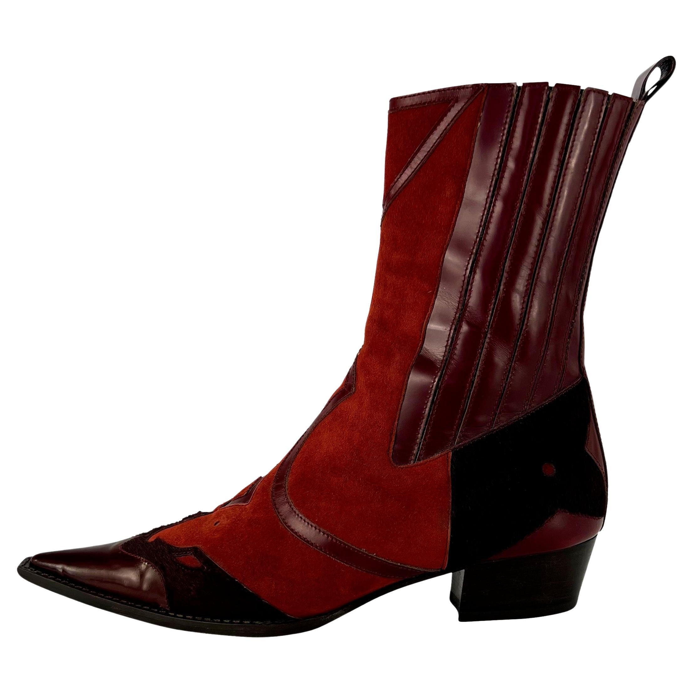 TheRealList presents: a pair of vibrant red and burgundy Dolce and Gabbana cowgirl boots. From the early 2000s, these incredible boots feature a small heel, patent leather toes, burgundy pony hair accents, and Western-style cutouts. 

Follow us on