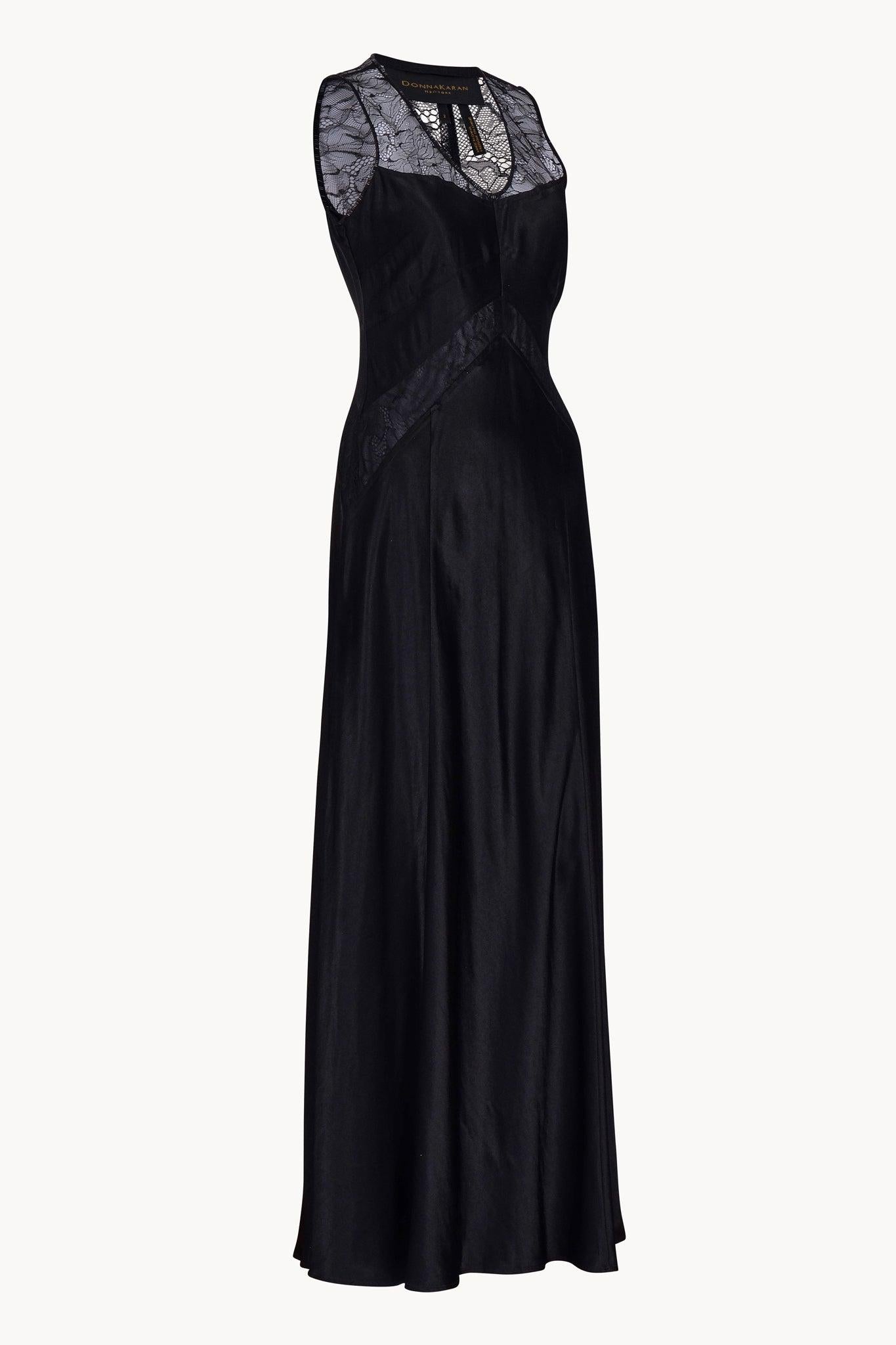 Beautiful 2000s Donna Karan black gown with delicate black floral lace panels on neckline and bodice. Features V neck shape, delicate black floral lace, black beads embellishment on neckline and arm openings.
