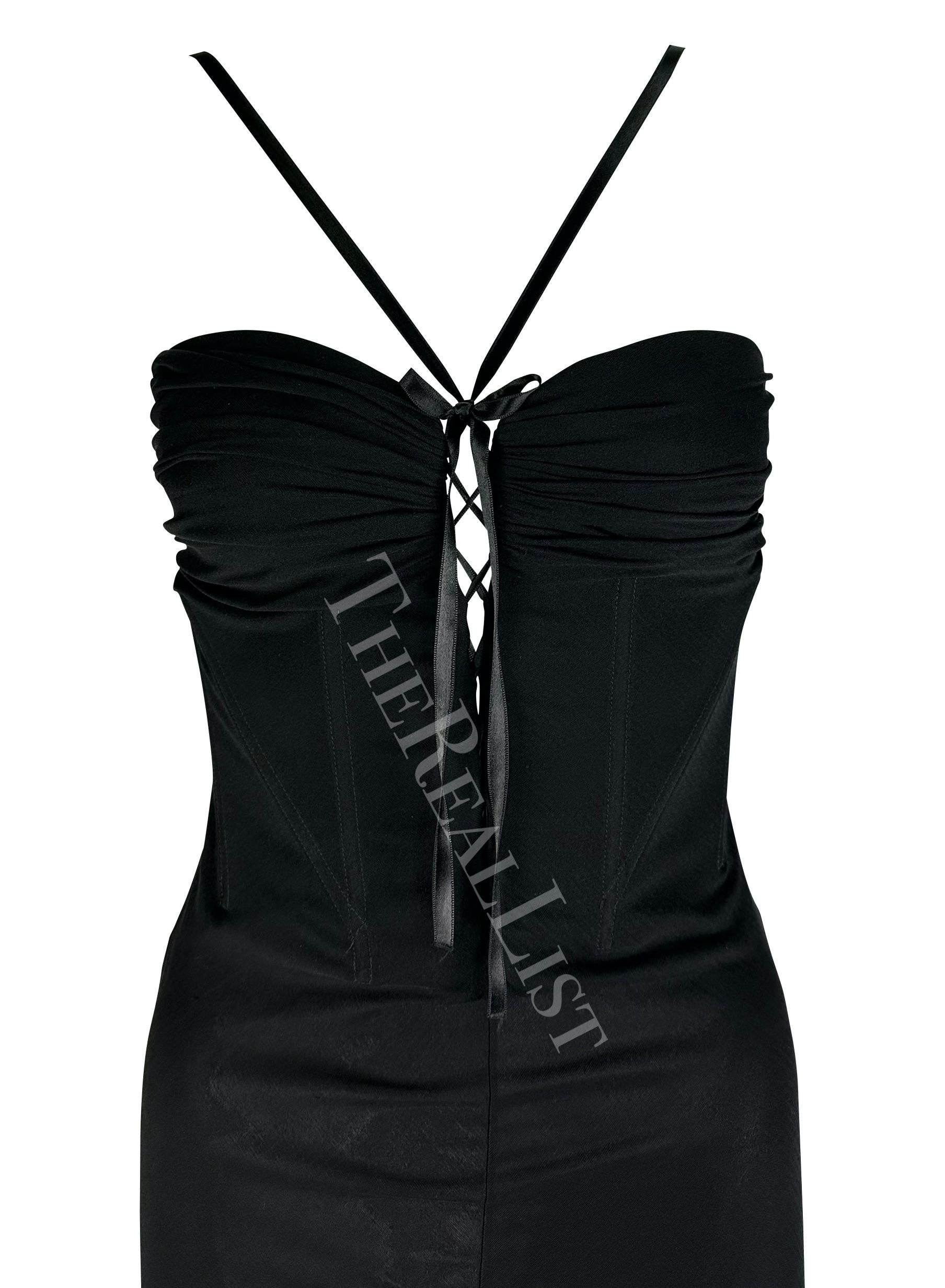 Presenting a beautiful black Emanuel Ungaro gown. From the early 2000s, this semi-sheer gown is perfectly feminine and sexy. The dress features a plunging neckline, with a lace-up detail between the breasts, an internal corset, and a symmetric