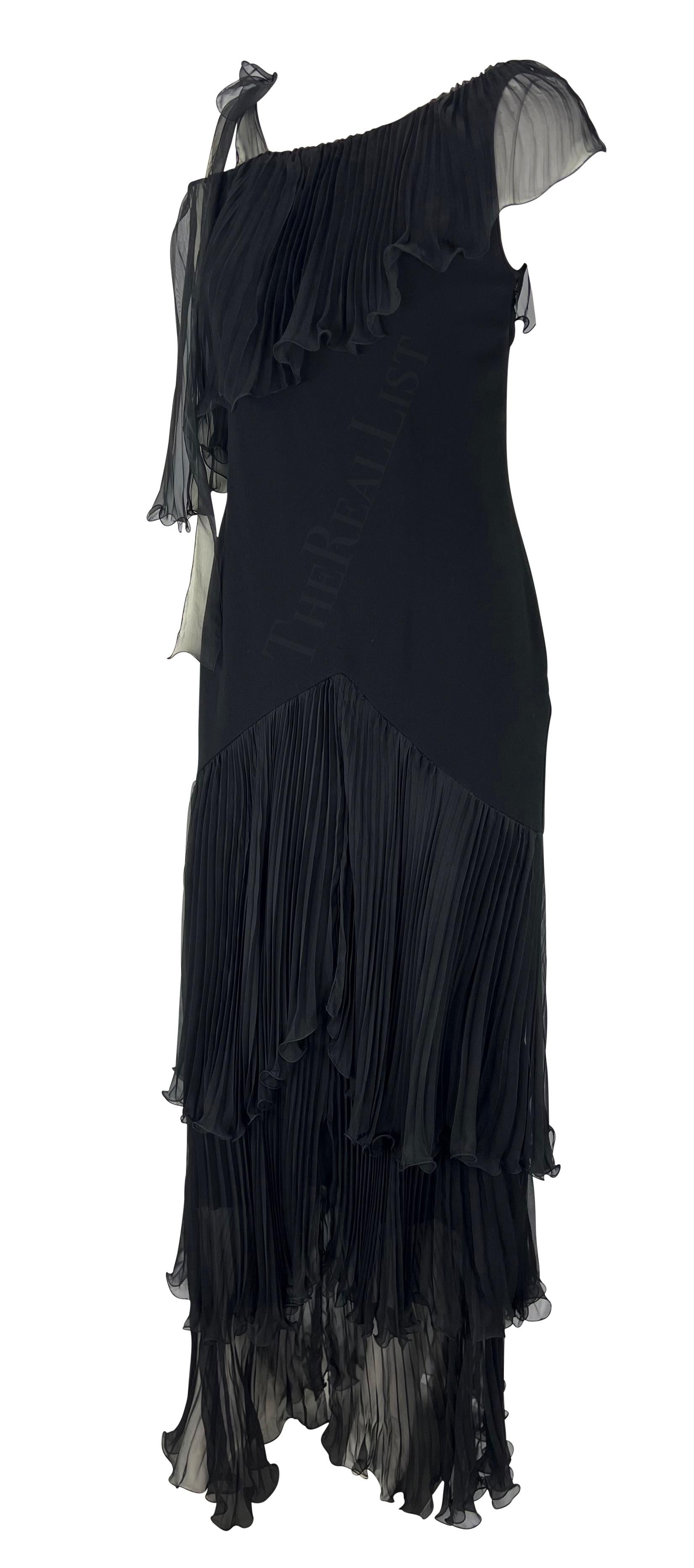 Presenting a black chiffon Emanuel Ungaro gown. Transport yourself to the glamour of the early 2000s with this exquisite floor-length dress. Its cascading tiers create a captivating movement that effortlessly commands attention. The alluring