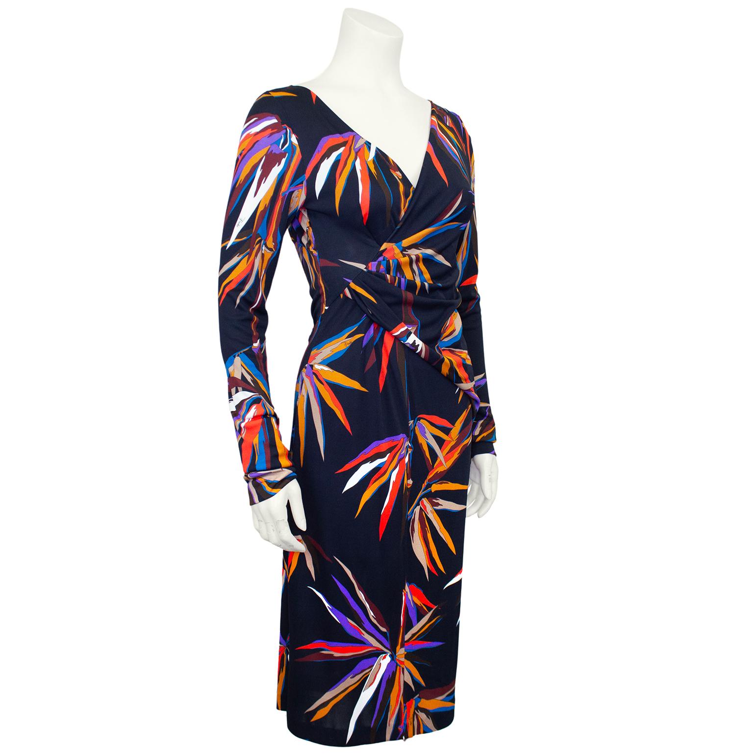 A departure from the abstract geometric prints, this 2000s Emilio Pucci dress is black and a large all over multicolour Birds of Paradise print. Crafted from a viscose and silk blend, this piece skims the body and is quite sexy. Long sleeve with a v