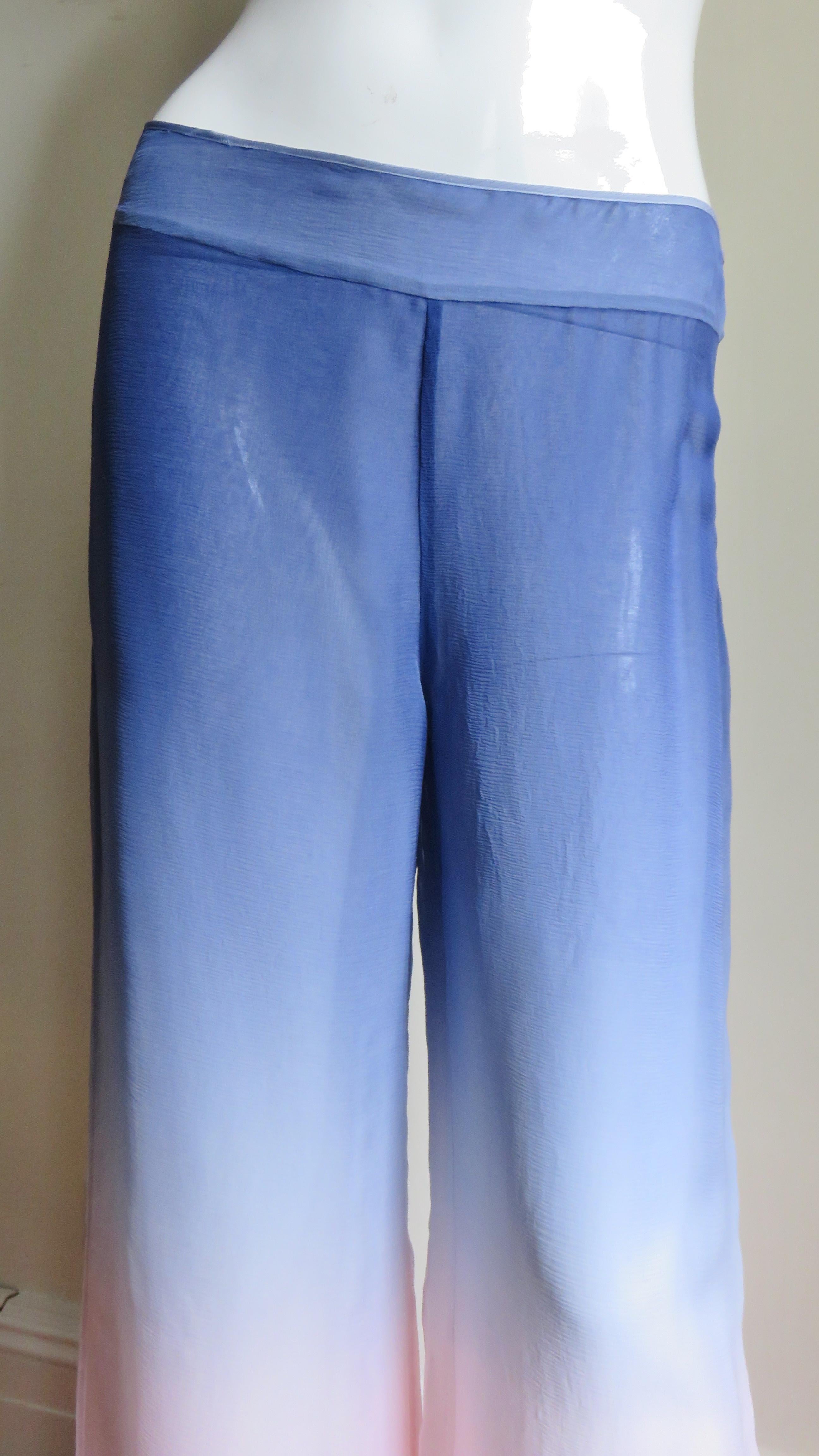 Beautiful wide leg silk pants from Emilio Pucci.  They consist of 2 layers of ombre silk starting with blue at the waistband lightening, melting into pink from the knees to the hem.  The have wide legs, a waistband and a side zipper.  
Unworn