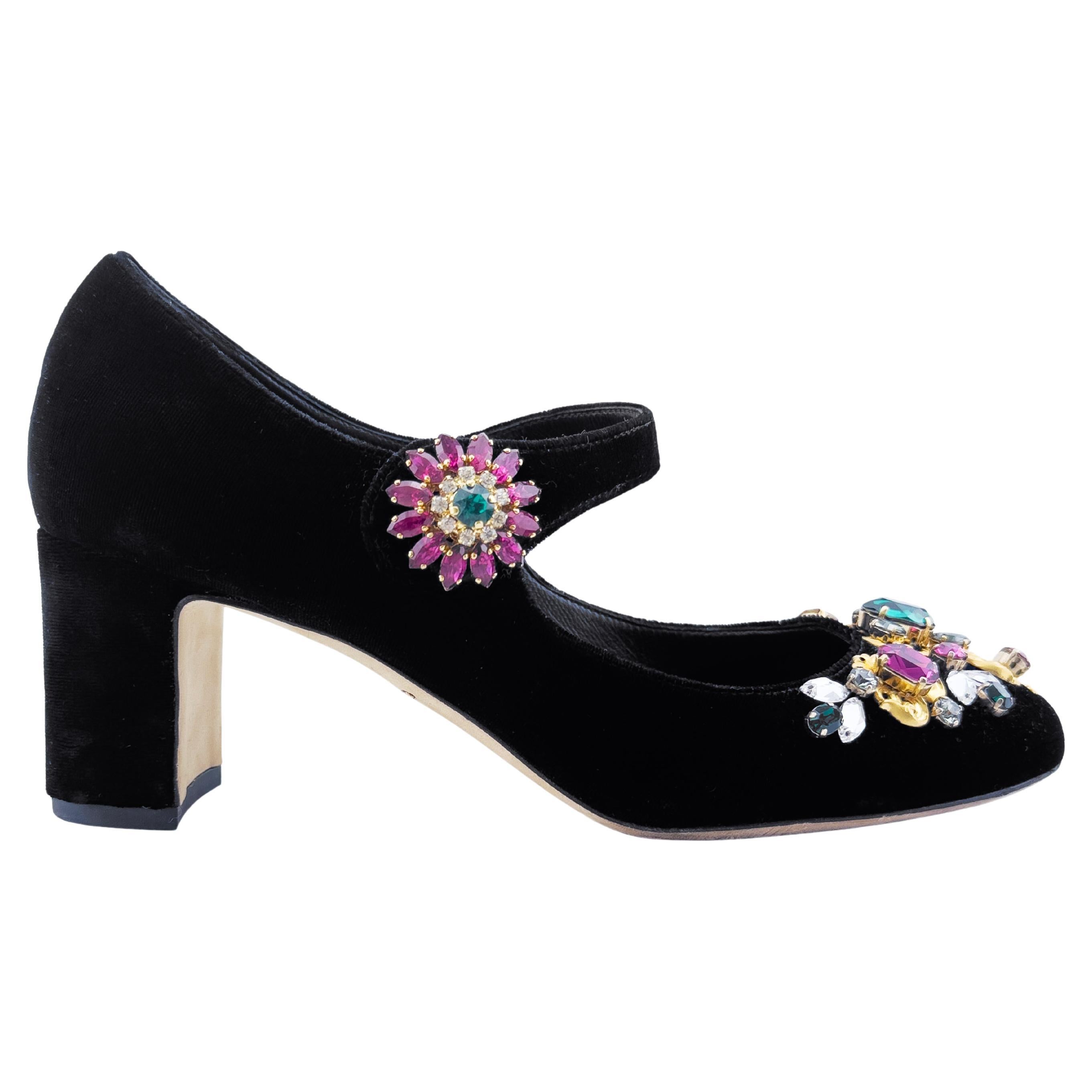 2000's era dreamy over-the-top Dolce and Gabbana Mary Janes. Black velvet with amazing encrusted toe boxes with large faux crystals in bright pink, turquoise and gold. The shoe is even further embellished with a large sunburst gold, pink and green