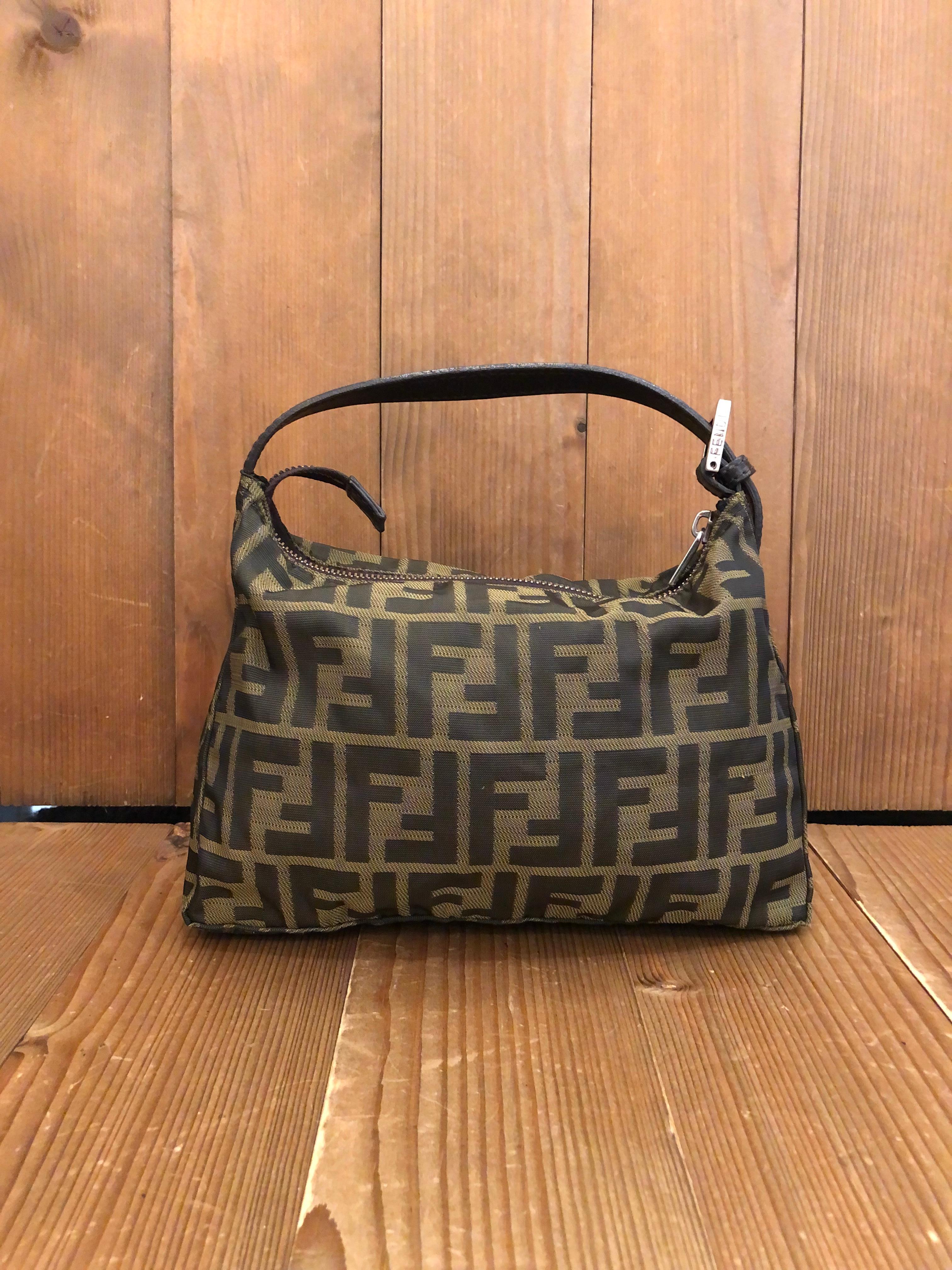 This vintage Fendi pouch handbag is crafted of Fendi's iconic brown Zucca jacquard featuring silver-toned hardware. Top zipper closure opens to an unlined interior. Made in Italy. Measures 9.5 x 6.5 x 4 inches Drop 4 inches. Compact in size but big