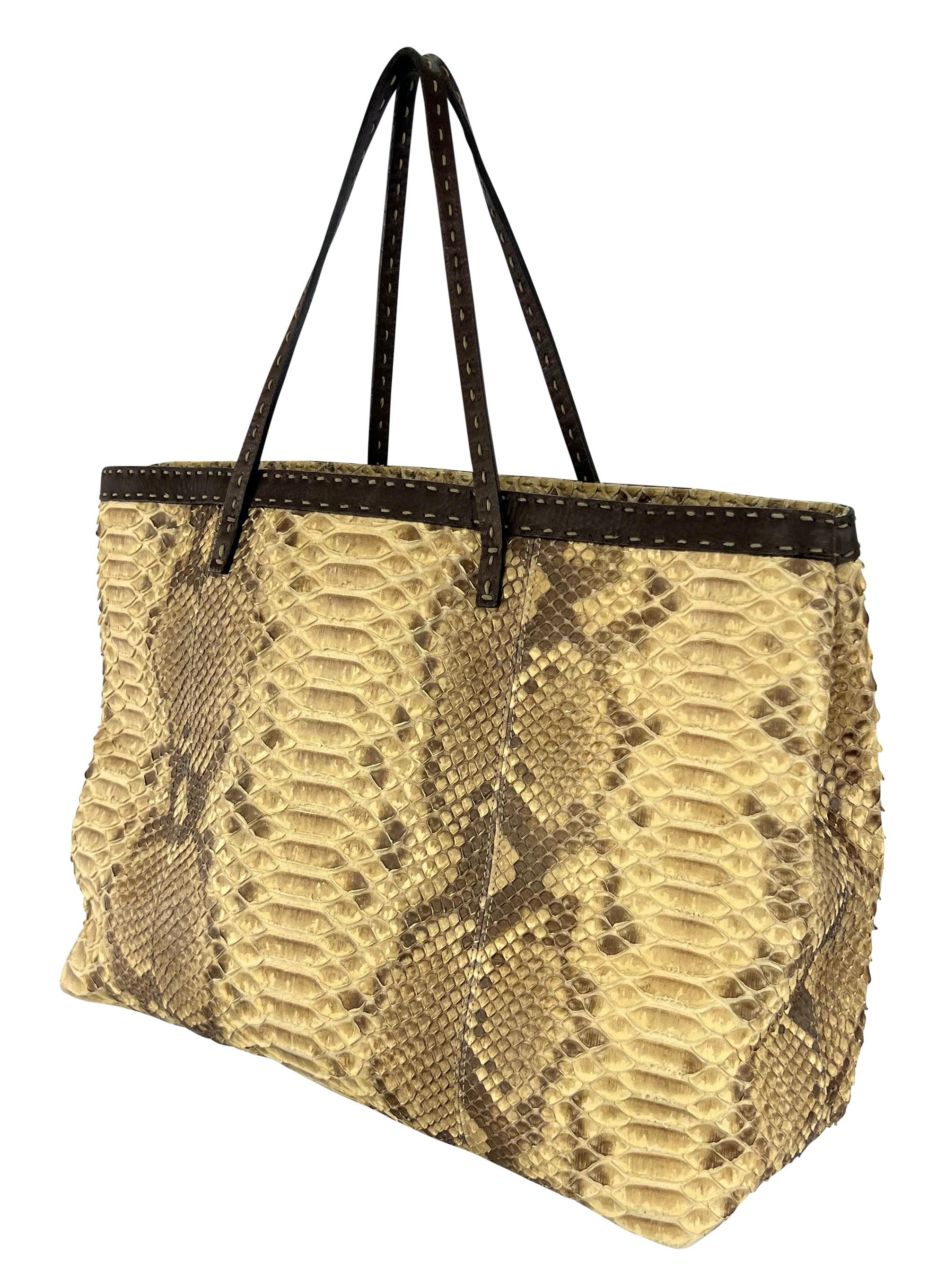 Karl Lagerfeld designed this medium Fendi Selleria shoulder tote in the 2000s. Crafted from genuine tan python skin, this handmade tote features dark brown leather trim and top-stitched double shoulder straps, showcasing the brand's artisanal